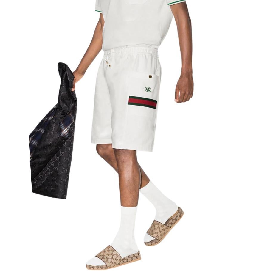 Gucci Web Stripe Cotton Track Shorts

-White Cotton Body
- elasticated waist with drawstring
- Two patch pockets with gold tone button
- Web stripe detail to pockets & GG Embroidery

Mid weight, fits true to size with a relaxed fit.

Body: Cotton