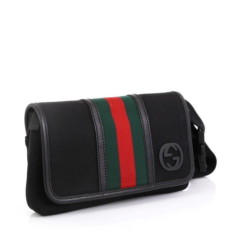 This Gucci Web Waist Bag Techno Canvas, crafted in black canvas, features an adjustable canvas belt strap, red and green web detail, and silver-tone hardware. Its flap and zip closure opens to a black fabric interior with slip pocket. These are