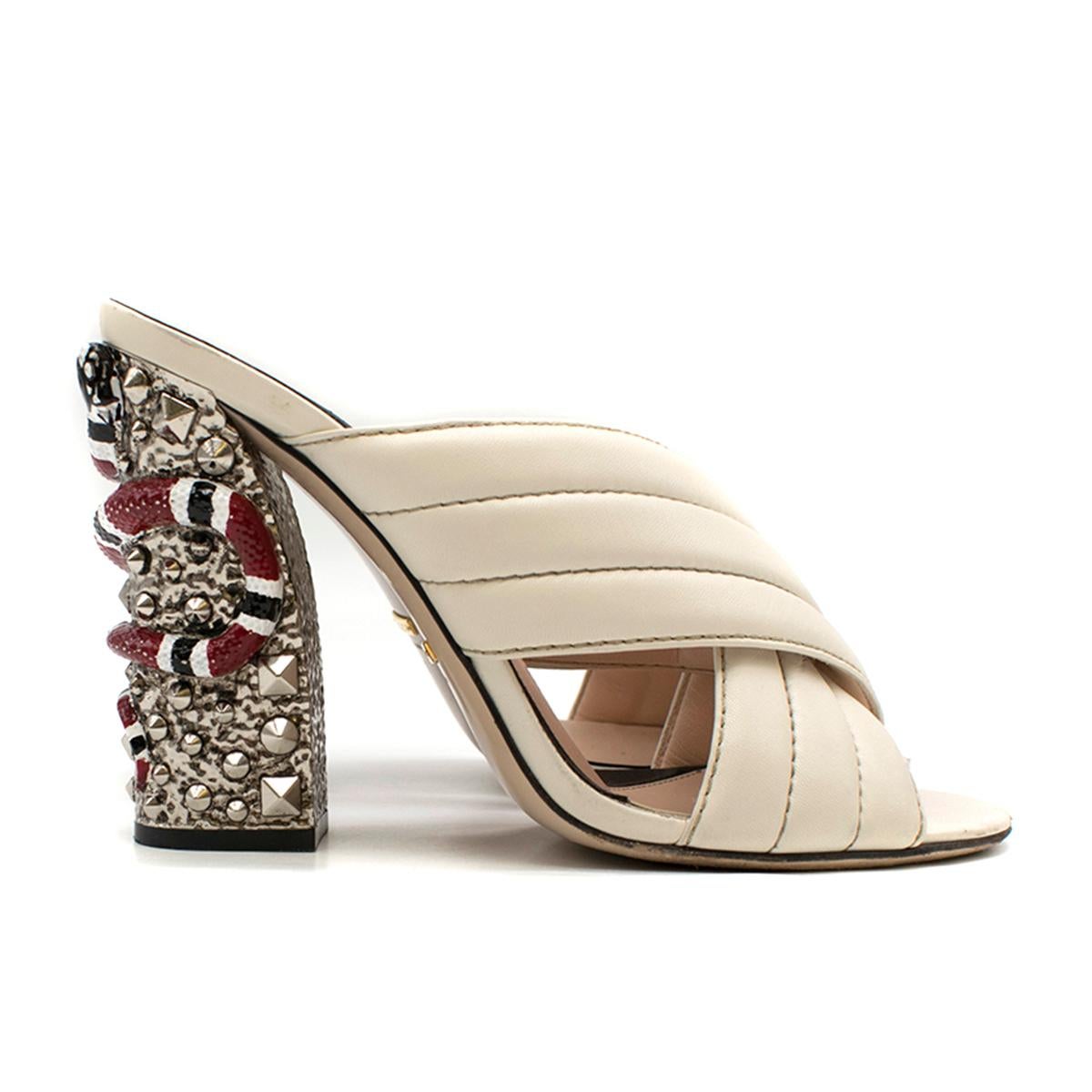 Gucci Webby Quilted Leather Snake-Heel Mule Sandal

- 'Webby' Mule Sandal 
- Handpainted Snake and Stud block heel 
- Quilted CrissCross vamp strap at front 
- Open toe.
- Slide style.
- Smooth outsole.
- Leather 

Please note, these items are