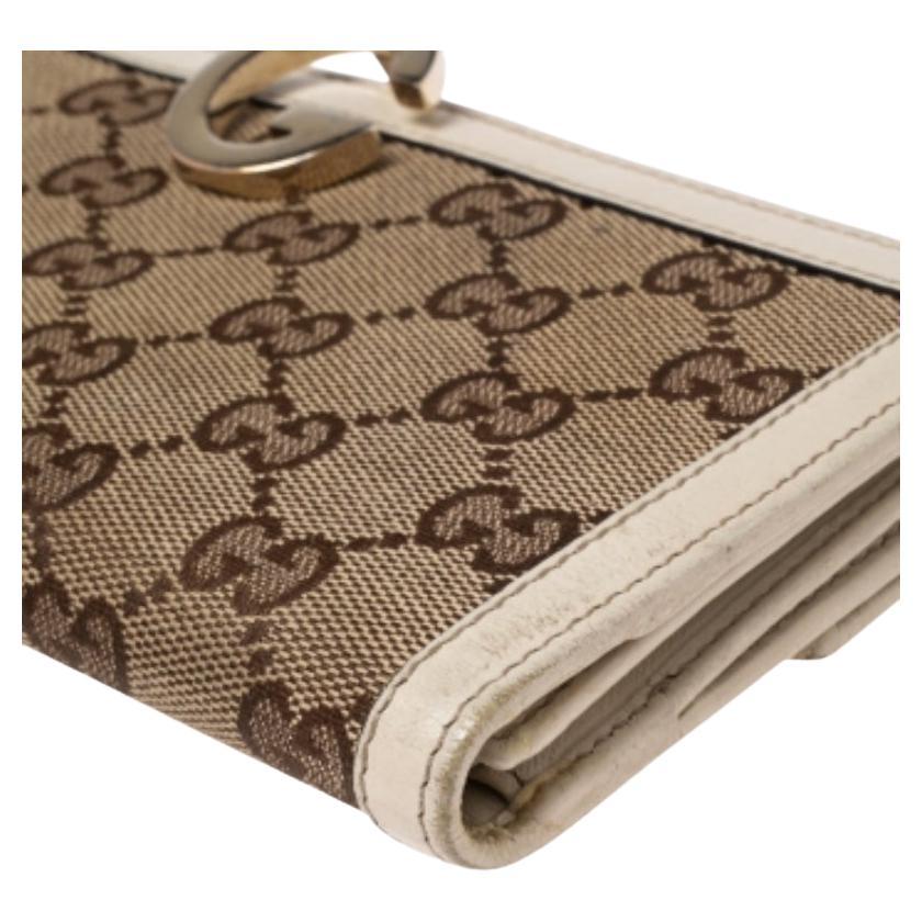 Classic and functional! The bifold long wallet from Gucci is made from the iconic GG canvas and leather. A must-have, the beige piece carries the gold-tone logo detail. The wallet opens to a leather and nylon lined interior, housing multiple card