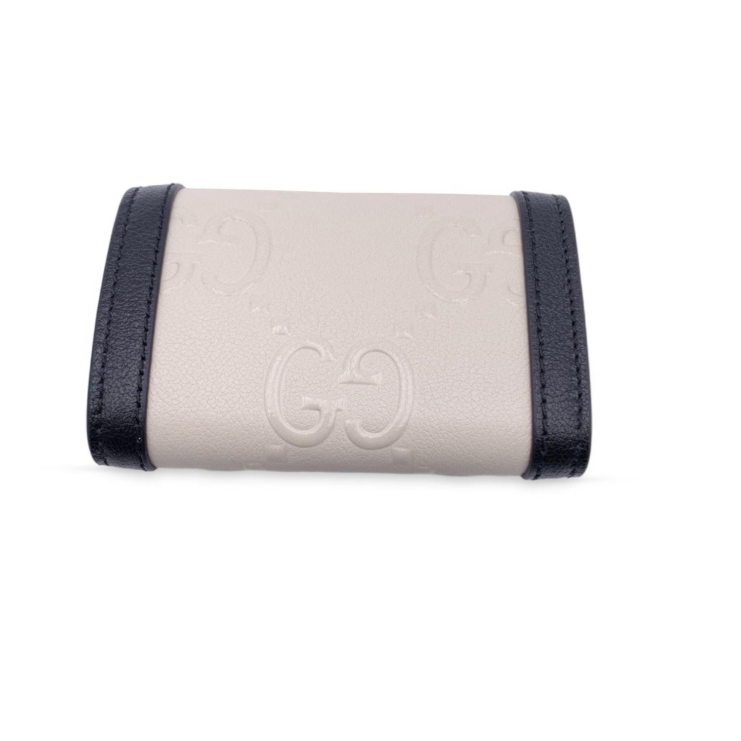 Gucci 'Wonka' Key case in black and white embossed monogram leather. Gold metal hardware. Snap closure on the front. Leather lining. 6 key rings inside. 'Gucci - Made in Italy' embossed inside. Retail price is 410 Euros Condition A - EXCELLENT In