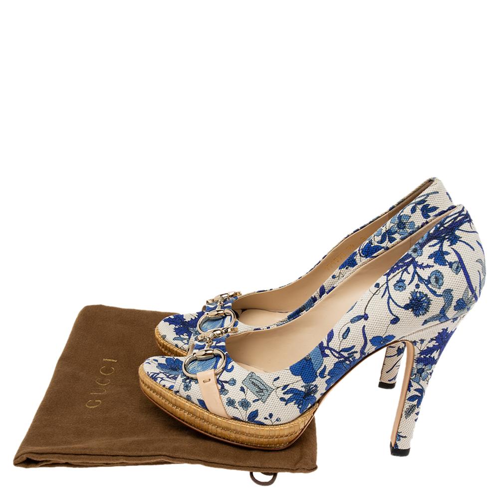 Adorned with a beautiful floral print and Gucci's aesthetics, these pumps will grant your feet unending charm, femininity, and poise! They are crafted using white-blue floral-printed canvas, with a gold-tone Horsebit motif perched to the peep-toes.