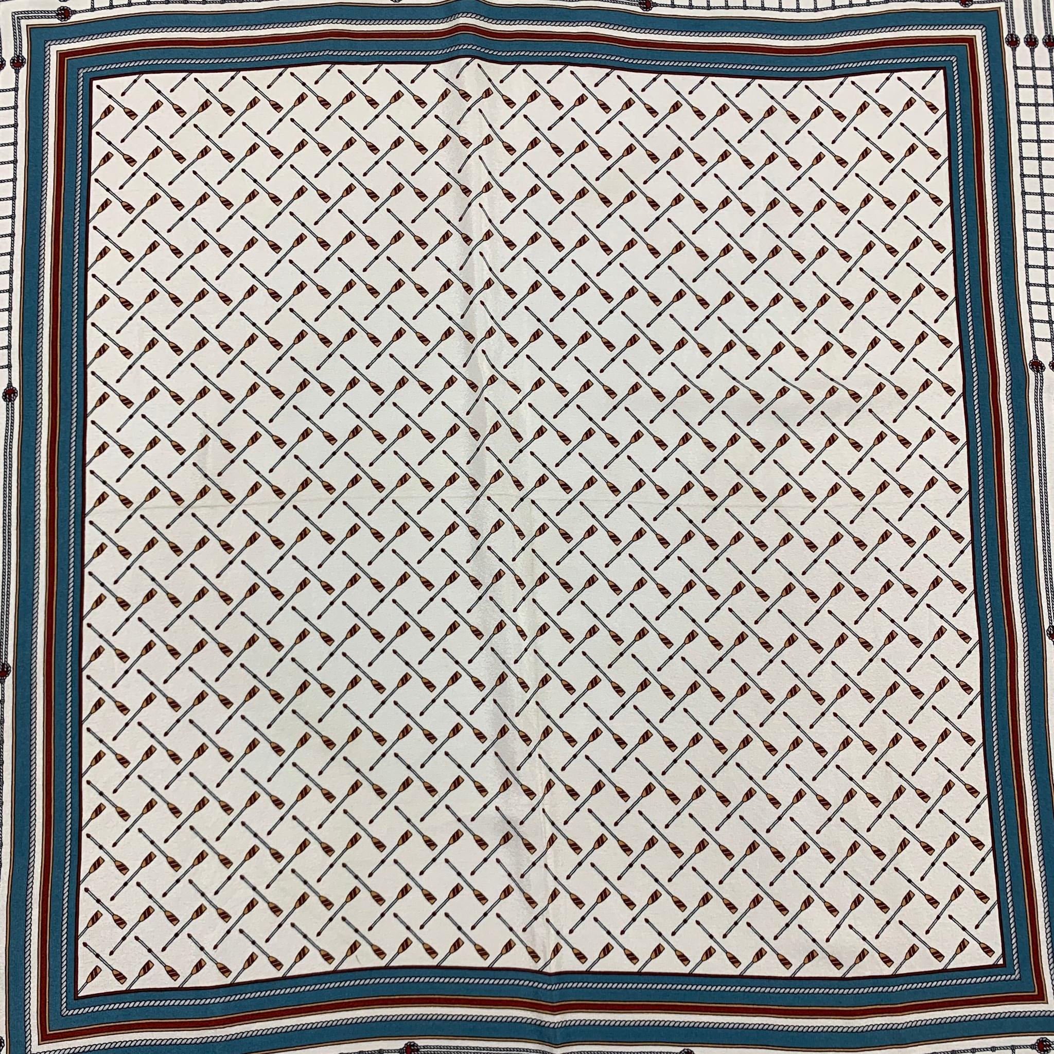 GUCCI scarf comes in a white & blue nautical print material featuring a square style. 

Good Pre-Owned Condition.

Measurements:

26 in. x 26 in. 