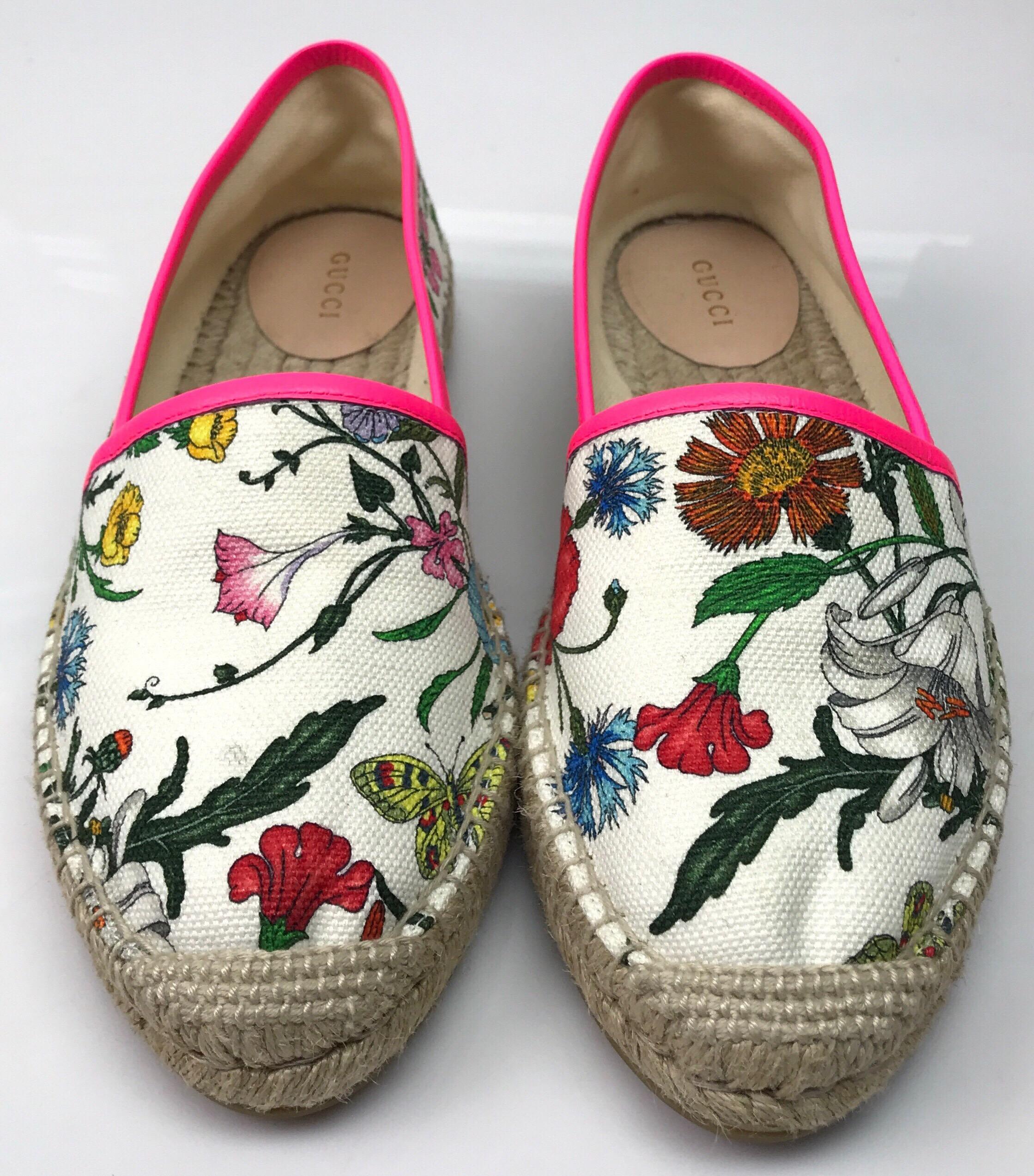 Gucci White Espadrille w/ floral pattern-38. These beautiful Gucci espadrilles are in great condition. They have small dirt marks, as shown in picture. They are a white cloth material with a floral pattern throughout. There is hot pink leather
