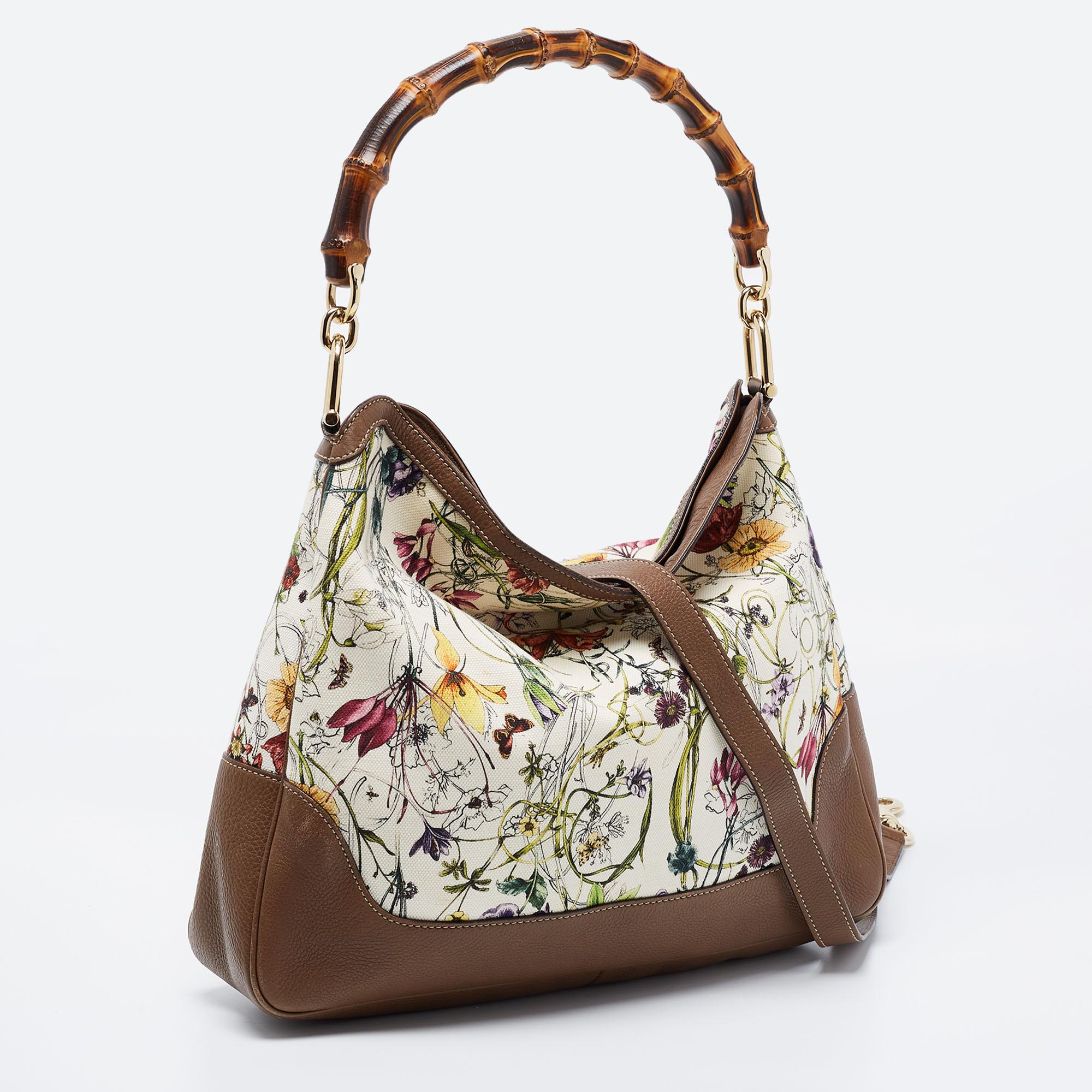 The eye-catching and enduring details of this Gucci bag make it a wise investment. Created from leather and beautiful floral canvas, the design gets a classic update with a bamboo handle at the top, and it is adorned with gold-tone accents. The