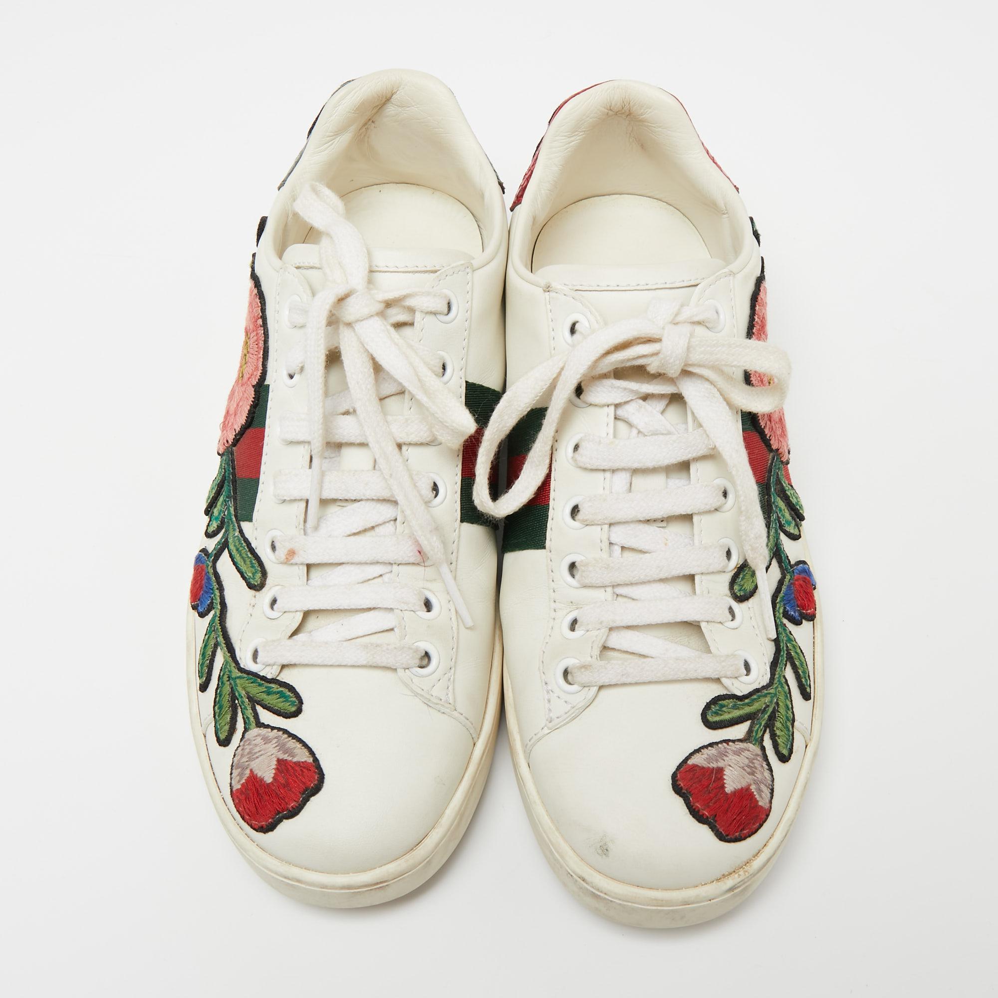 How one's heart flutters at the sight of these Gucci sneakers! Beautifully crafted from leather, they carry the signature web stripe and floral embroidery on the sides. Sneakers are definitely the rage at the moment but these Gucci ones are just a