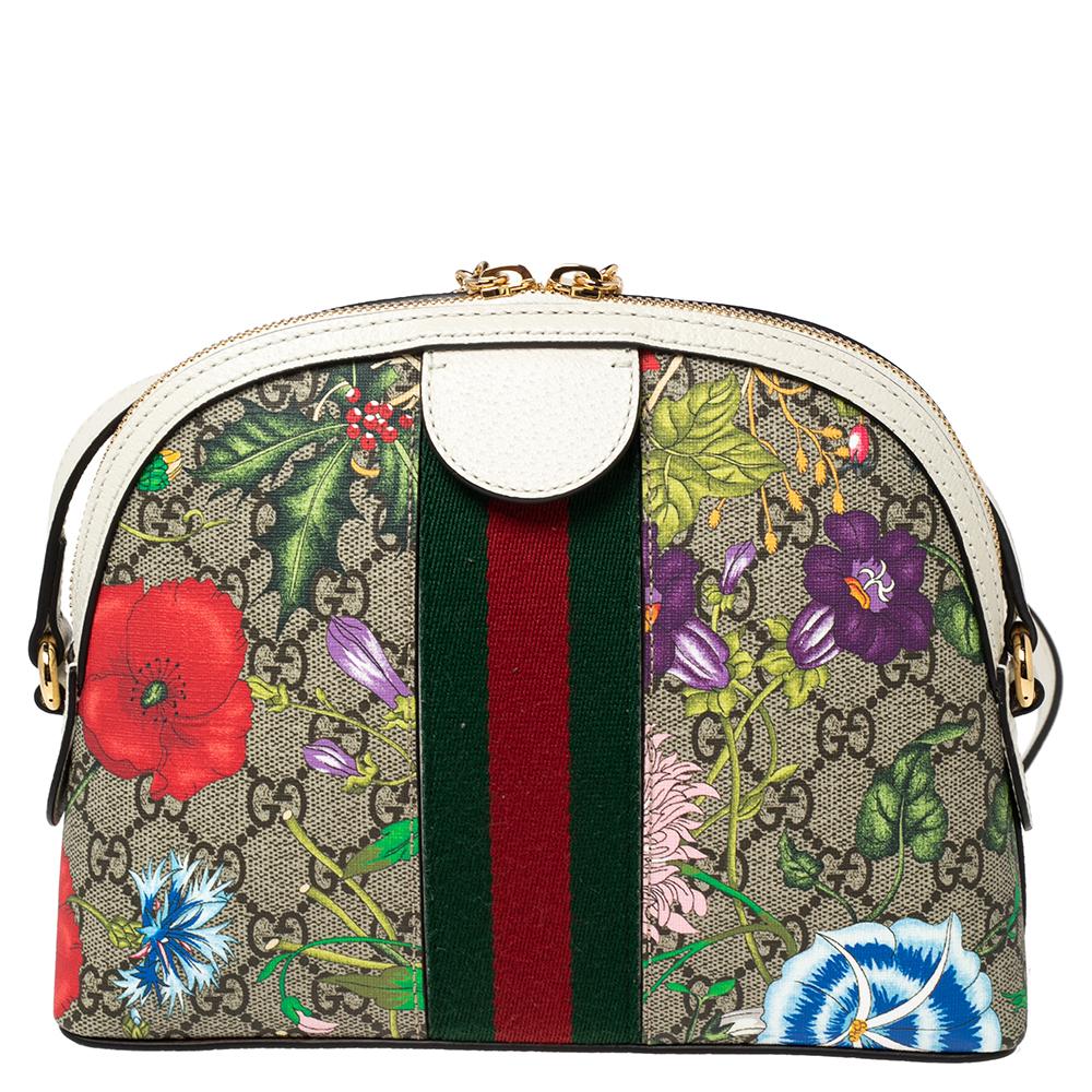 Crafted from GG Supreme canvas and white leather, this Gucci Ophidia bag comes in a structured shape for a sophisticated look. It features the iconic Web stripe, Flora prints, and the GG motif—all Gucci codes. The bag suspends from a shoulder