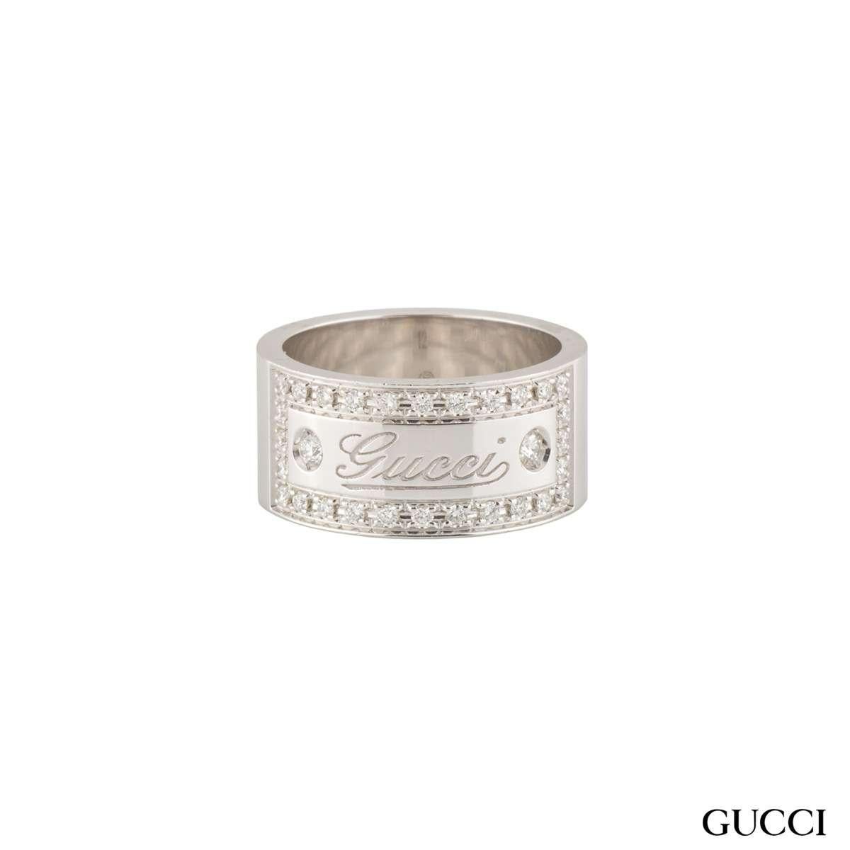 A beautiful 18k white gold diamond Gucci ring. The ring comprises of a 9mm flat court band with the 'Gucci' logo embossed in the centre. The logo has a box around set with diamonds with a weight of approximately 0.49ct, G colour and VS+ clarity. The