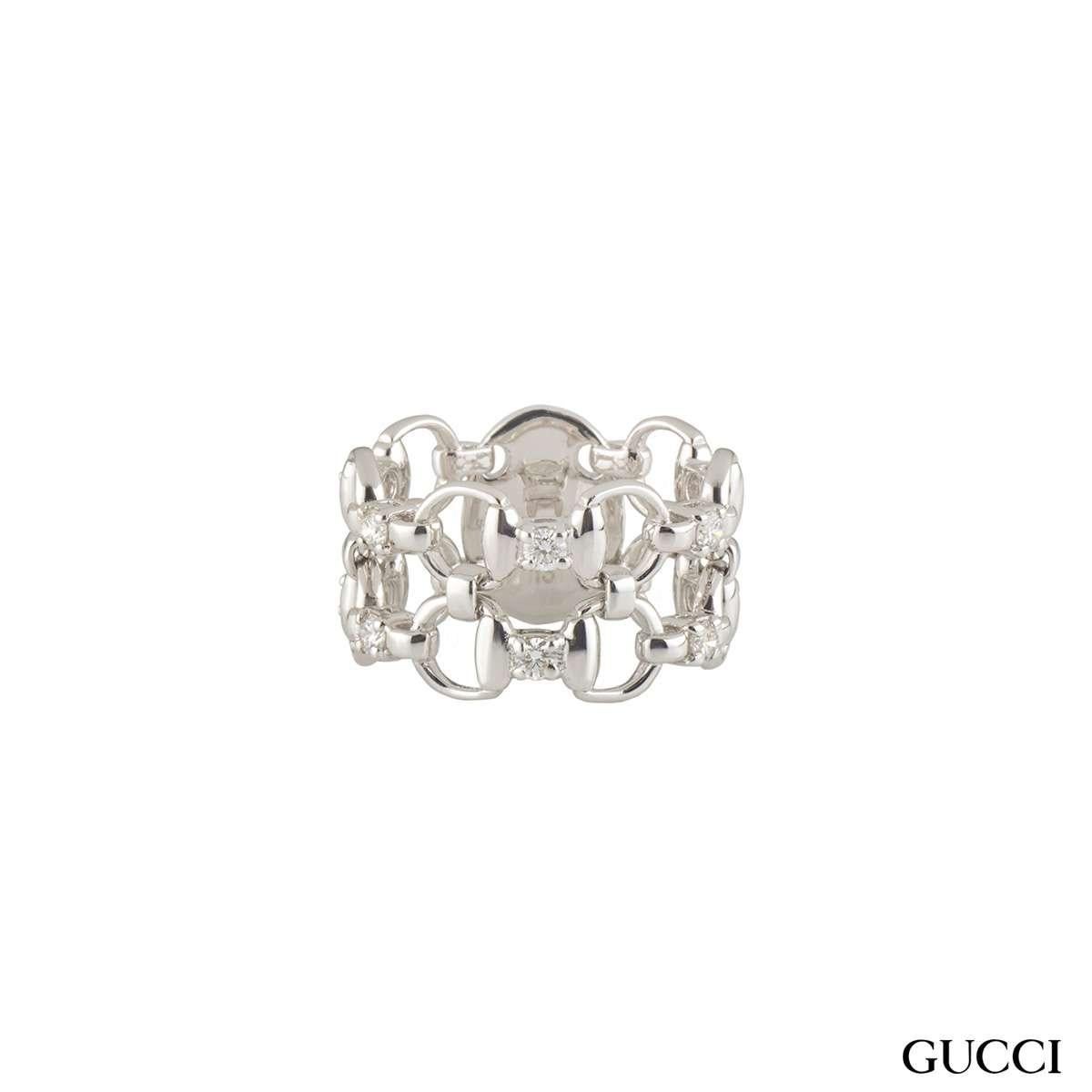 A simple 18k white gold plain Gucci diamond ring from the Horsebit collection. The ring comprises of the open work iconic horseshoe design all the way around with round brilliant cut diamonds even spread around. The diamonds have a total approximate