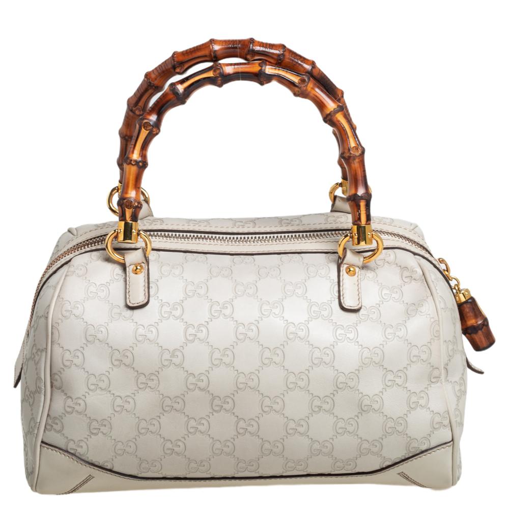 Gucci brings to you this amazing Boston bag that is smart and very modern. Made in Italy, this white bag is crafted from Guccissima leather and styled with two bamboo handles. The bamboo zipper reveals a fabric-lined interior with enough space to