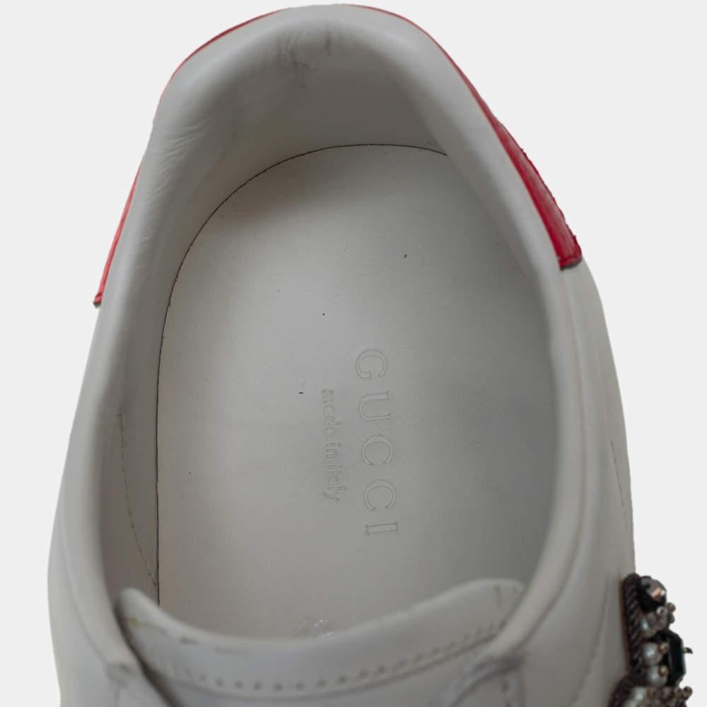 Stacked with signature details, this Gucci pair is rendered in leather and is designed in a low-cut style with lace-up vamps. The white sneakers have been fashioned with the iconic web stripes and embellished arrow and red heart motifs on the sides.