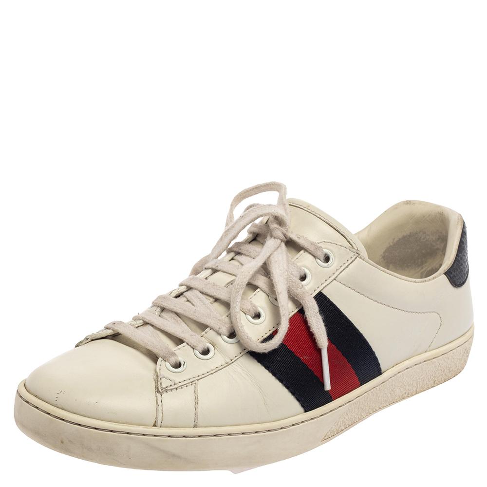 Stacked with signature details, this Gucci pair is rendered in leather and is designed in a low-cut style with lace-up vamps. The white sneakers have been fashioned with the iconic web stripes. Complete with blue trims carrying the brand label on