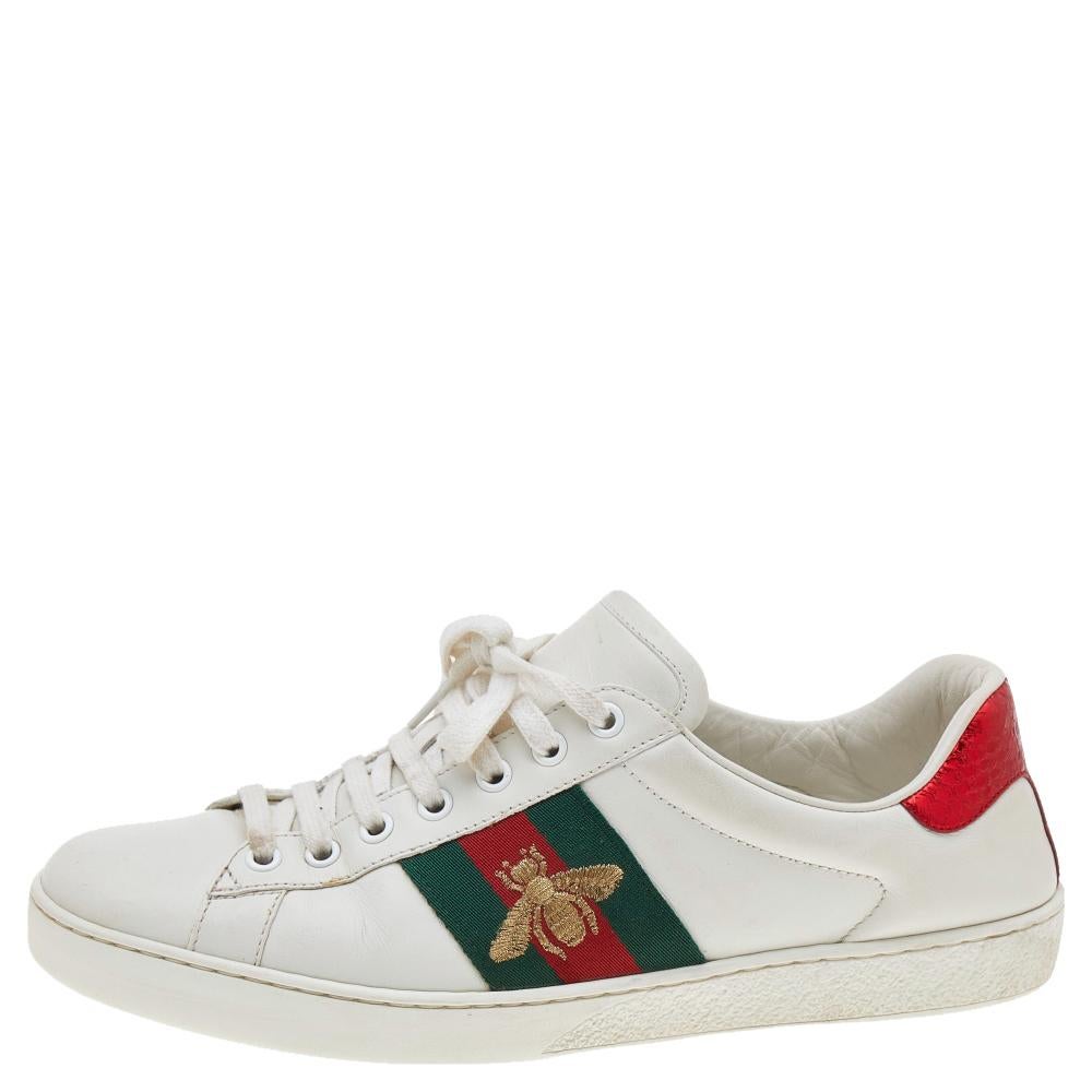 Stacked with signature details, this Gucci pair is rendered in leather and is designed in a low-cut style with lace-up vamps. They have been fashioned with the iconic web stripes and bee motifs. Complete with red and green trims carrying spikes on