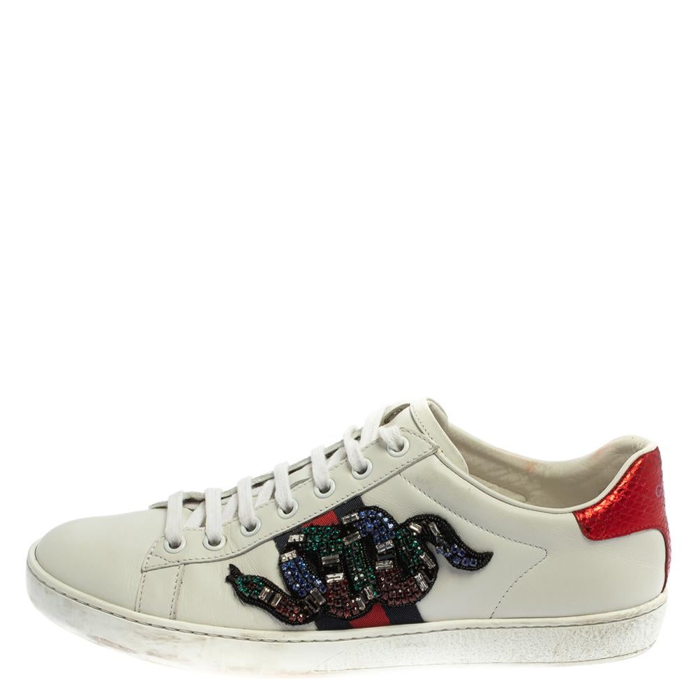 Stacked with signature details, this Gucci pair is rendered in leather and is designed in a low-cut style with lace-up vamps. They have been fashioned with the iconic web stripes and crystal-embellished snake motifs. Complete with red and blue trims