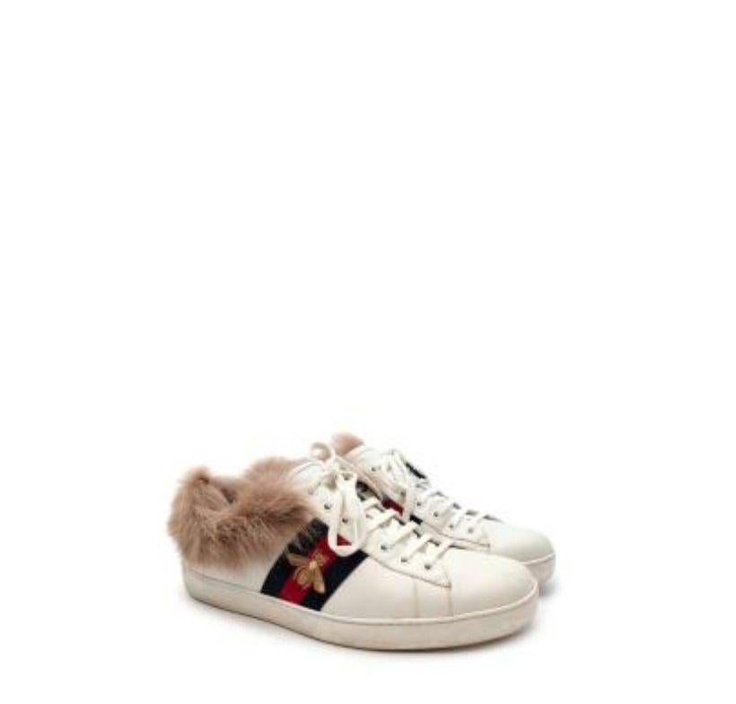 Gucci White Leather Ace Trainers with Lambs Fur Trim
 
 - Iconic ace sneaker in white leather with bee embroidered web stripe
 - Lined with brown lambs fur, which is visible around the neck of the trainer
 - Lace up
 - Rubber sole 
 
 Materials:
