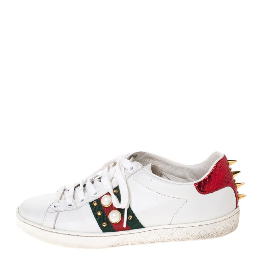 Stacked with signature details, this Gucci pair is rendered in leather and is designed in a low-cut style with lace-up vamps. They have been fashioned with the iconic web stripes and a mix of spikes, studs and faux pearls. Complete with red and