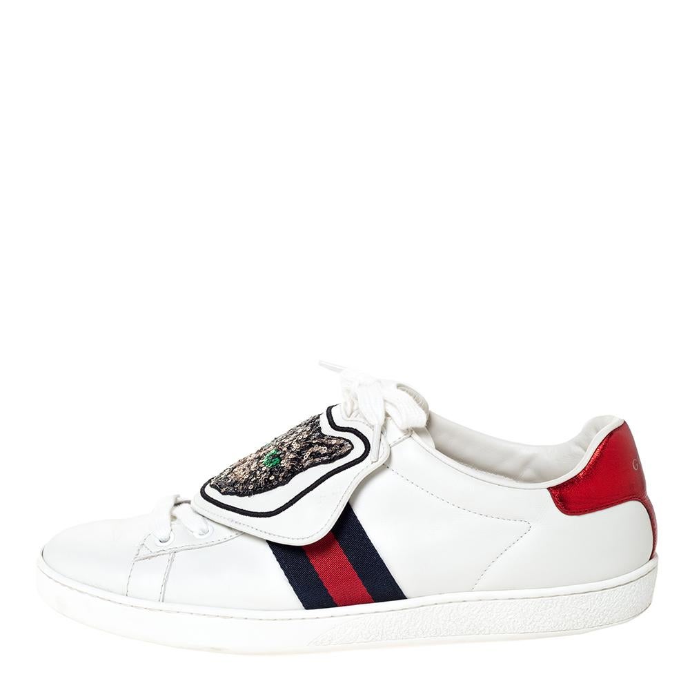 Stacked with signature details, this Gucci pair is rendered in white leather and is designed in a low-cut style with lace-up vamps. They have been fashioned with the iconic web stripes and removable patches. Complete with red and blue trims carrying