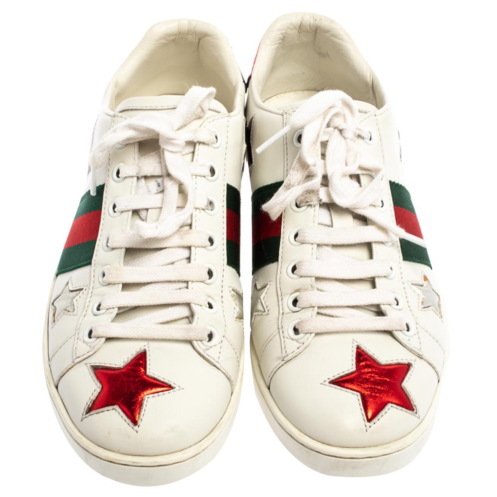 Stacked with signature details, this Gucci pair is rendered in leather and is designed in a low-cut style with lace-up vamps. The sneakers have been fashioned with the iconic web stripes and decorated with star parches. Complete with red and green