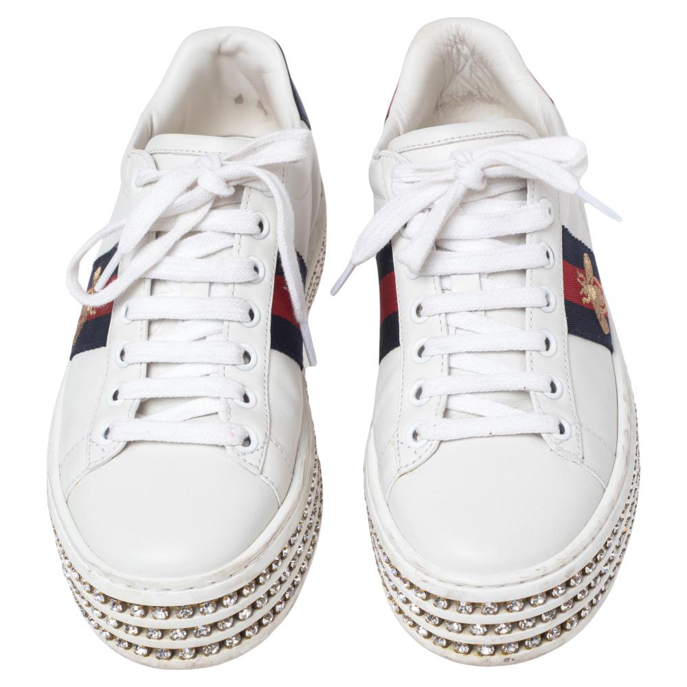 Walk out in style with this pair of sneakers from Gucci. These leather sneakers are fashionable and definitely worth the splurge. These white New Ace sneakers feature platforms embellished with crystals, web detailing embroidered with the signature