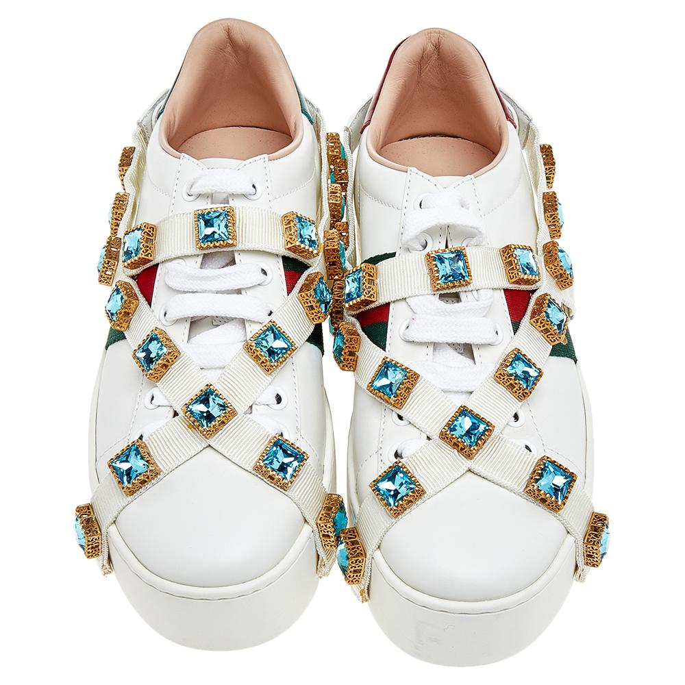 Walk out in style with this pair of sneakers from Gucci. These leather sneakers are fashionable and definitely worth the splurge. These white Ace sneakers feature platforms, crystal embellishments on the crossover canvas straps, web detailing