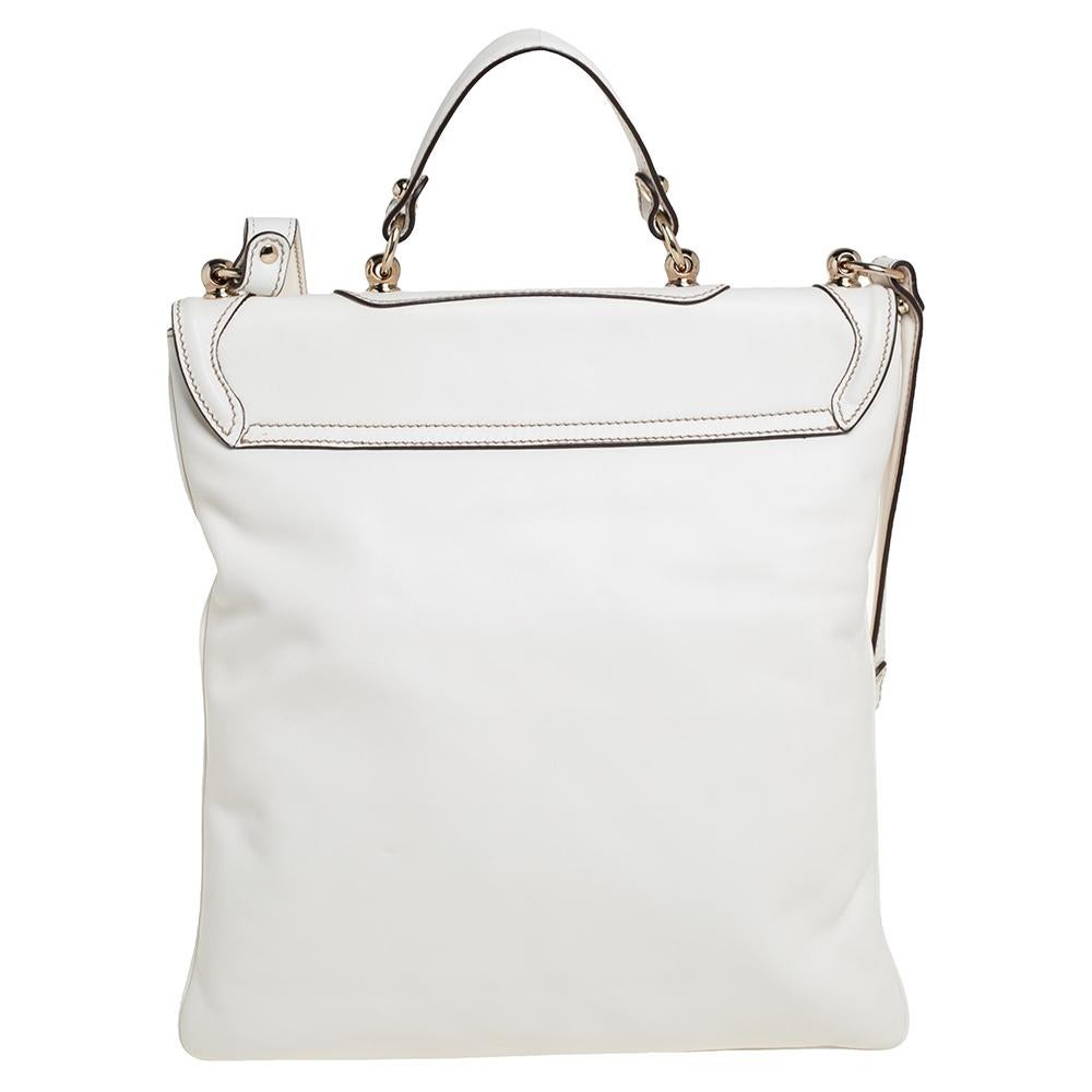 A stunning companion for your outings, this wondrous Britt messenger bag by Gucci is one of its kind. It has been crafted in white leather. The exterior features pockets, GG logo, a shoulder strap, a top handle, and gold-tone hardware. The flap