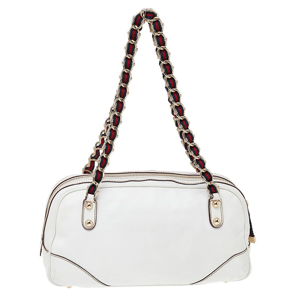 This Capri bowler bag from Gucci is what your wardrobe has been missing all this while! The bag is crafted from leather and flaunts dual zip pockets on the front and woven handles on top. The signature web zipper pulls add to the bag's overall