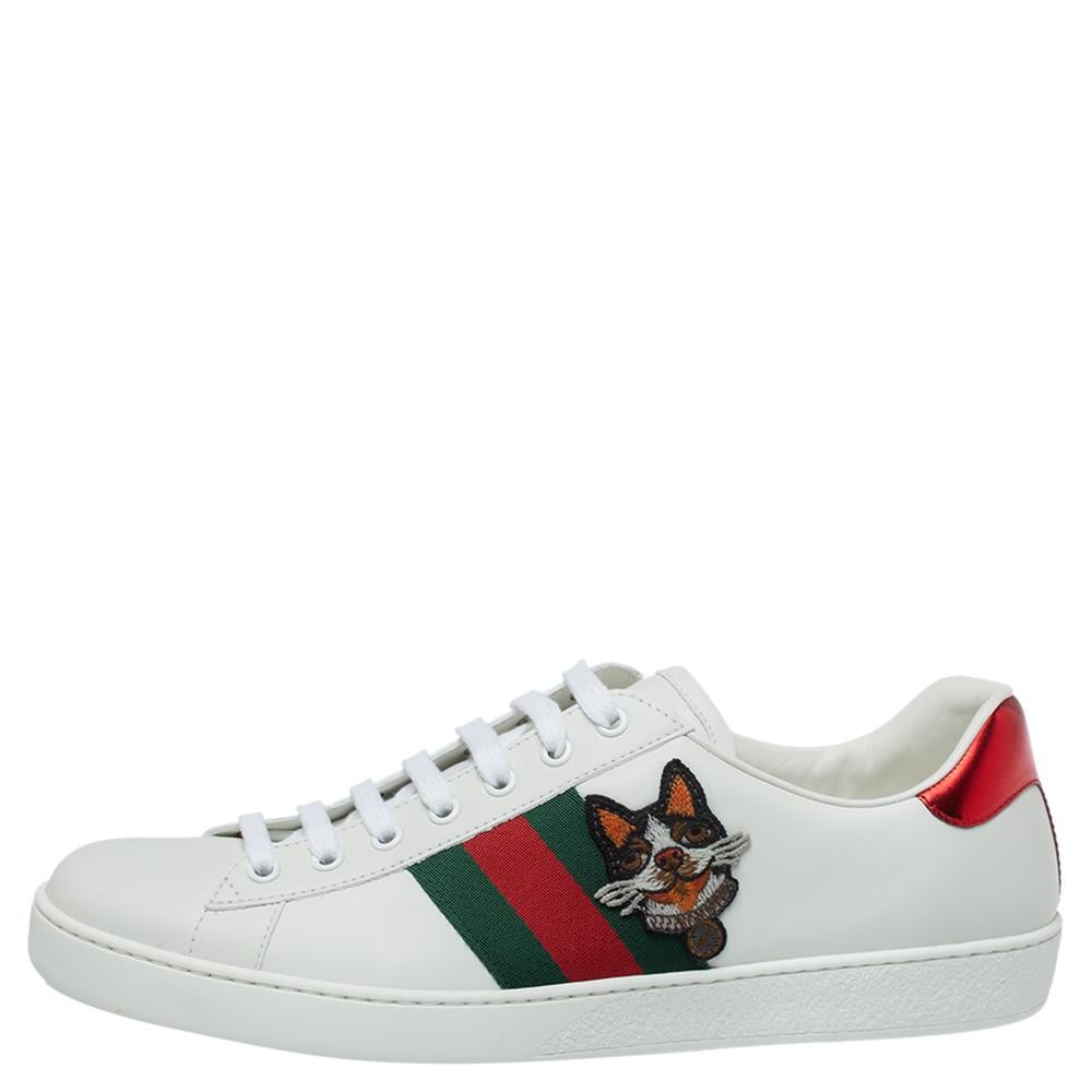 Stacked with signature details, this Gucci pair is rendered in leather and is designed in a low-cut style with lace-up vamps. They have been fashioned with the iconic web stripes and dog embroidery on the sides. Complete with red and green trims