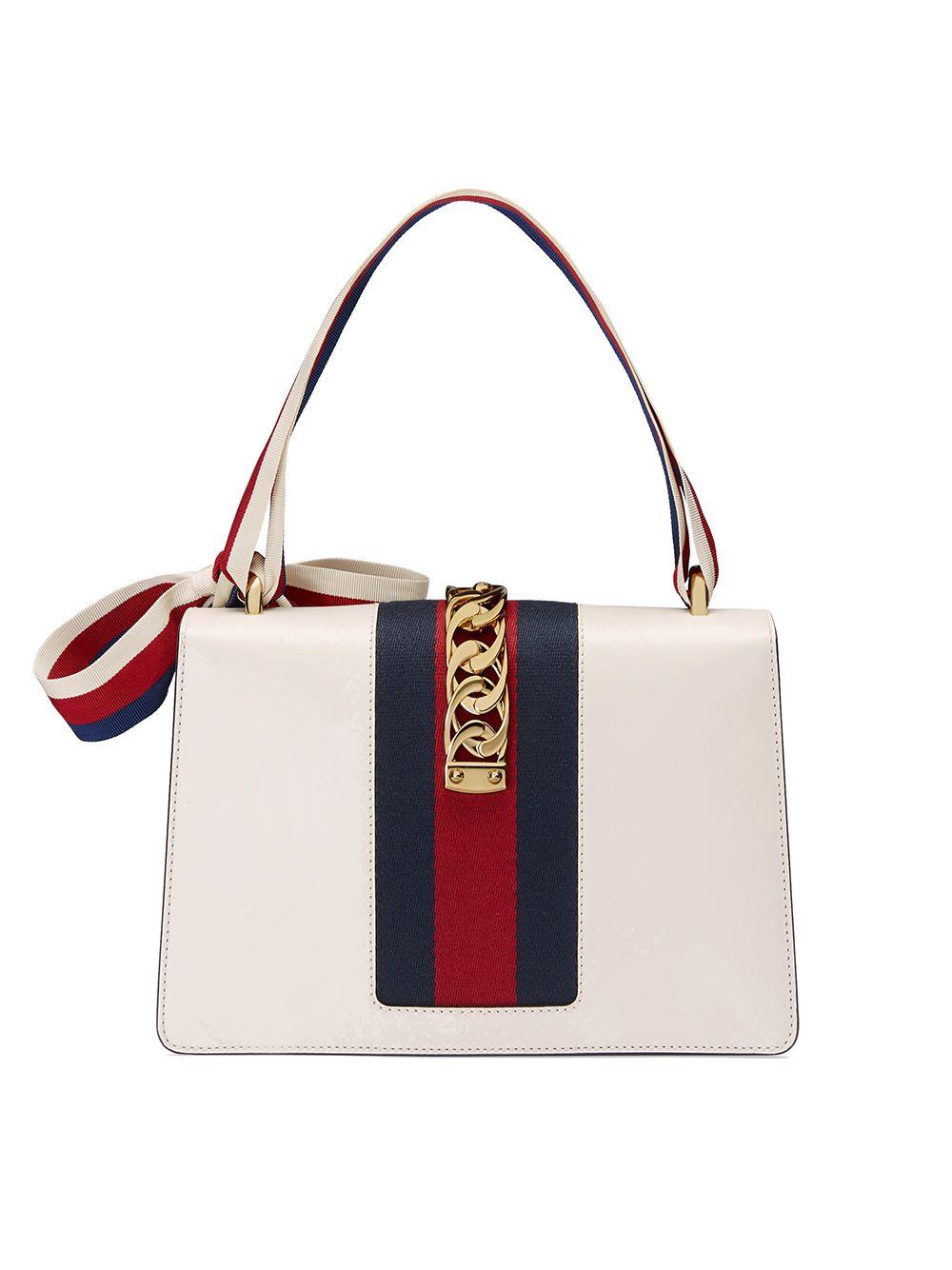 This Sylvie Gucci shoulder bag is the small model form the summer/spring 2018 Cruise collection. This bag is made of leather and features a top handle, a front bow, gold tone hardware, a front flap closure and suede interior lining.

COLOR: