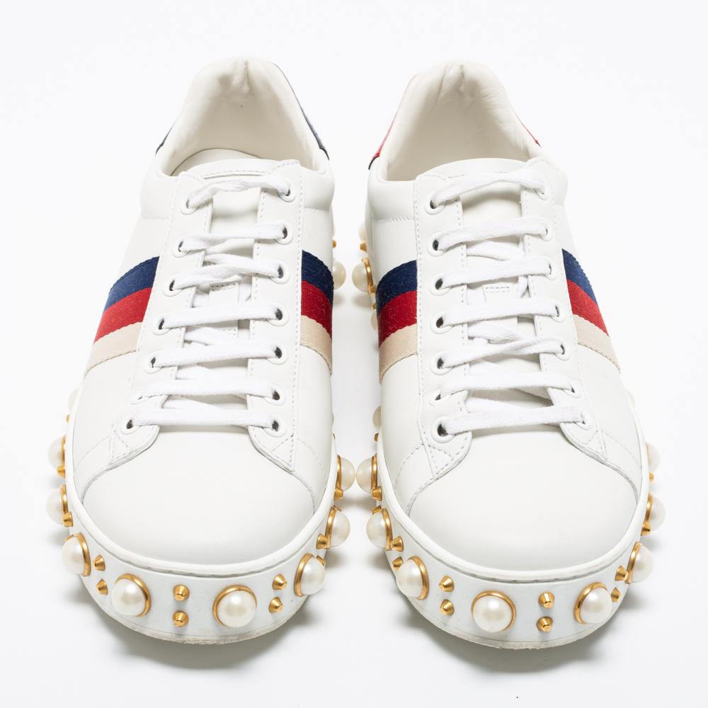 Fashioned to take your style a notch higher, these stunning New Ace sneakers from Gucci are worth the splurge! Made from white leather, they show the signature Web stripe detailing on the sides. They are further highlighted with pearl accents,