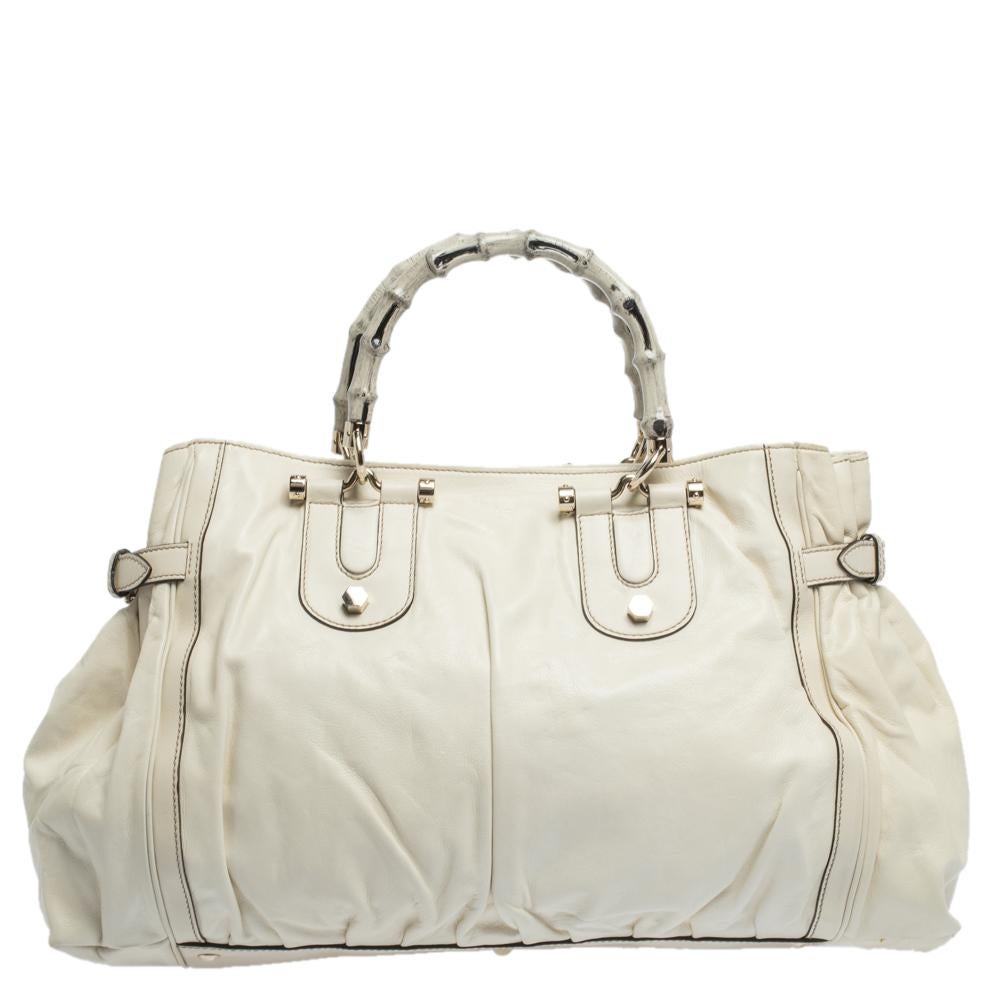 Handbags as fabulous as this one are hard to come by. Crafted from white leather, this stunning number by Gucci has a spacious nylon interior and is wonderfully held by two bamboo handles which make the piece worthy of being in your closet.

