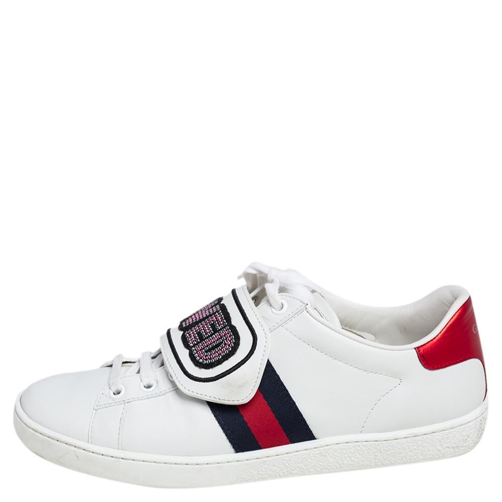 Stacked with signature details, this Gucci pair is rendered in leather and is designed in a low-cut style with lace-up vamps. The white sneakers have been fashioned with the iconic web stripes and crystal-embellished 'loved' patches. Complete with