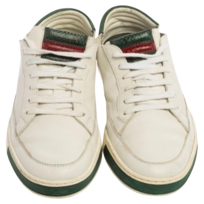 Let this pair of low-top Gucci sneakers elevate your style this season. Crafted from white leather, these sneakers feature round toes and lace-ups on the vamps. They have been detailed with the signature Web pattern on the tongues and made
