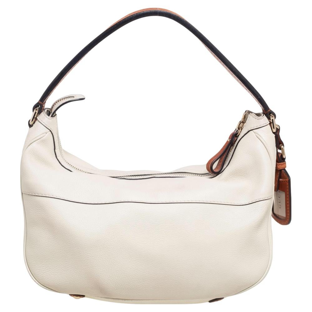 This Madison hobo from Gucci is simple yet stylish in its design. Crafted from leather, it features a white hue, a single top handle, and a zip pocket at the front. Complete with a spacious interior, this bag is perfect for everyday use.

Includes: