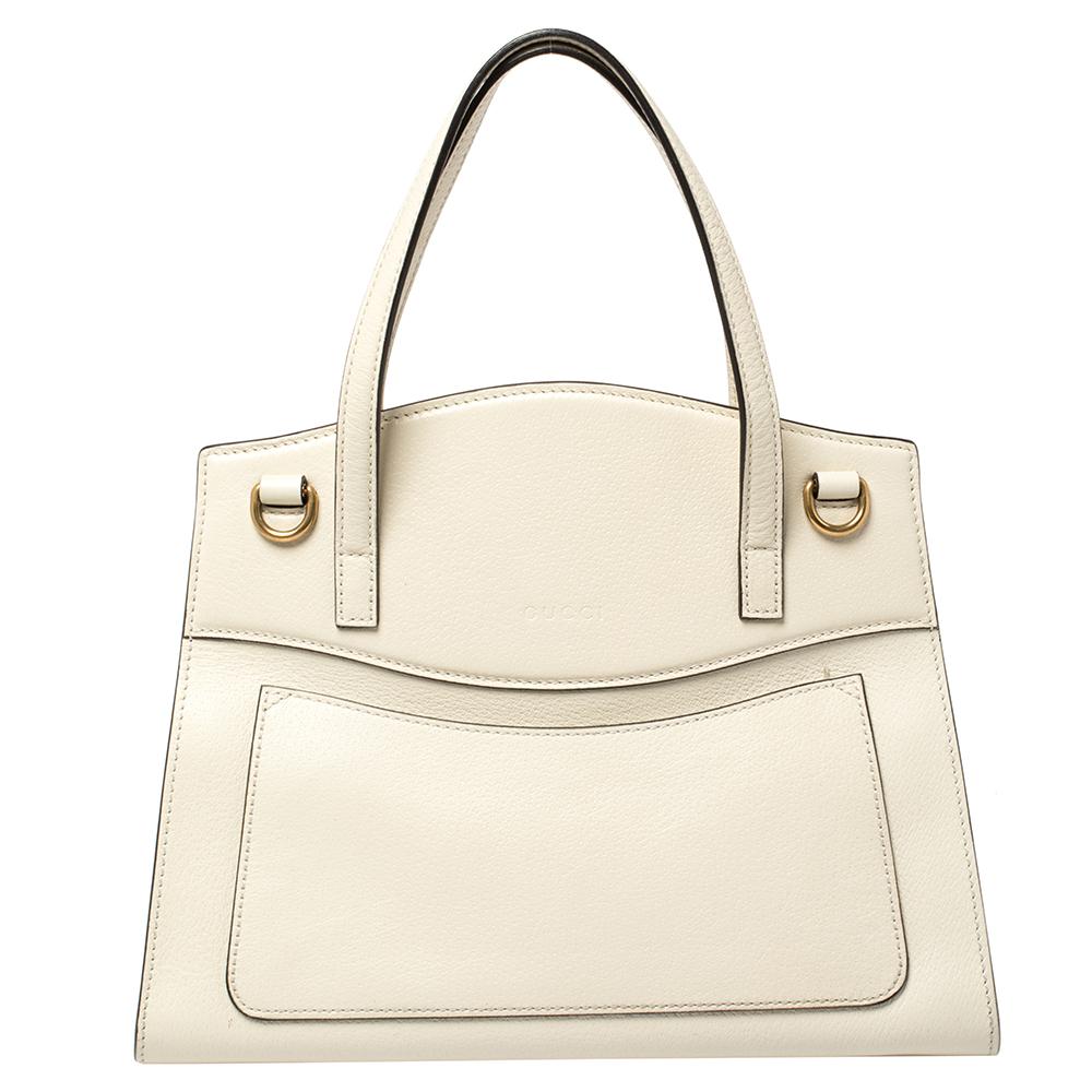Give your wardrobe an instant boost with this elegant leather handbag by Gucci. Crafted from white leather, the flap has a red and green web detail, embellished with a prominent gold butterfly brooch set with crystals. This flap snaps open to the
