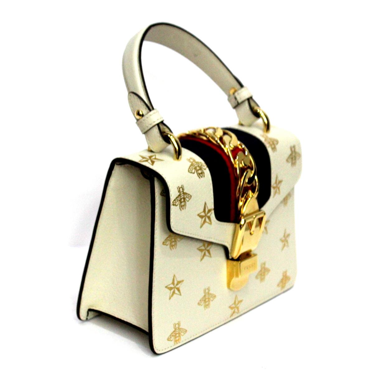 Fantastic Gucci Sylvie Bee Star line bag in its mini size Made of white leather with bees print and gold stars. Gold hardware, enriched by the classic red and blue Web tape. Closure with hook, internally large for the essentials, Equipped with a