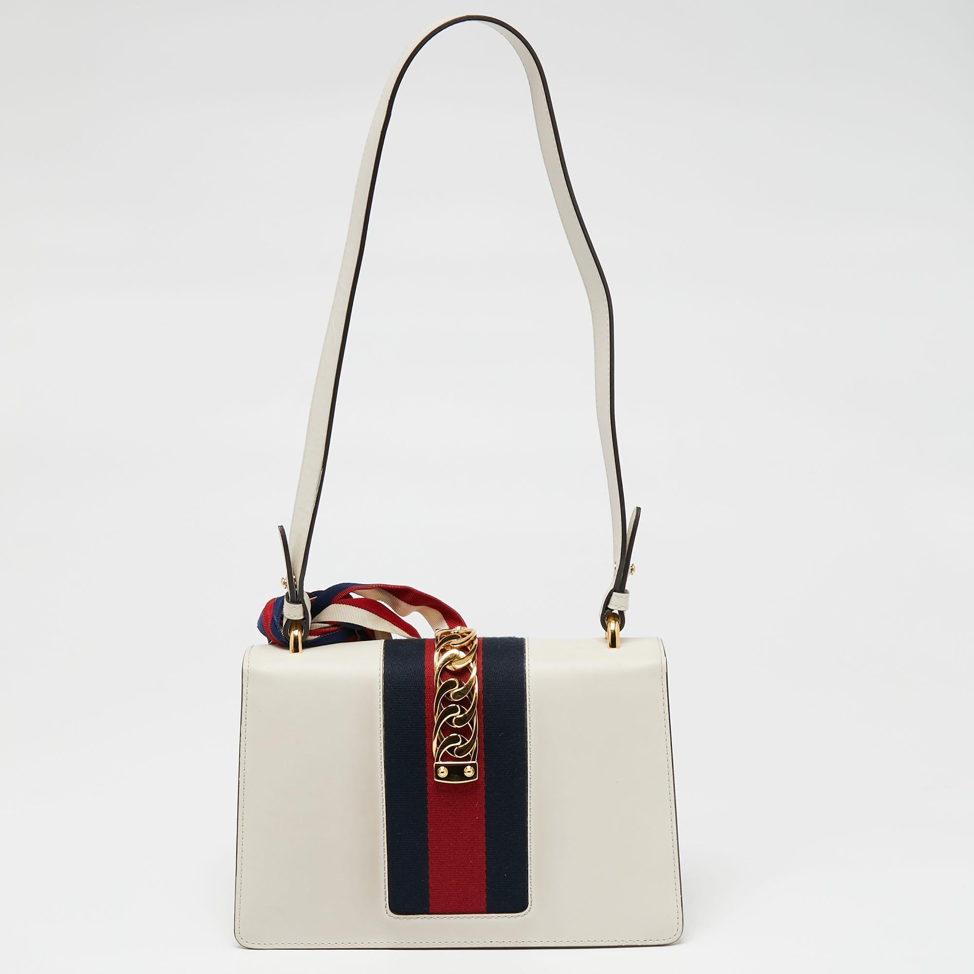 The gorgeous Gucci shoulder bag will perfectly complement all your outfits. It has an elegant, structured silhouette highlighted by a decorative trim on the flap. The interior is sized well to carry your daily essentials with ease.

Includes: Strap,