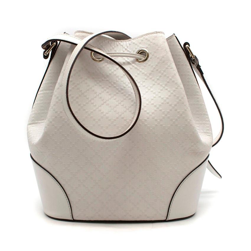 Gucci White Medium Leather Bucket Bag

- Diamante leather with leather trim.
- Light gold toned hardware.
- Reinforced leather panels with hand-painted edges.
- Adjustable strap
- Leather tag with embossed Gucci trademark.
-Drawstring closure.
-