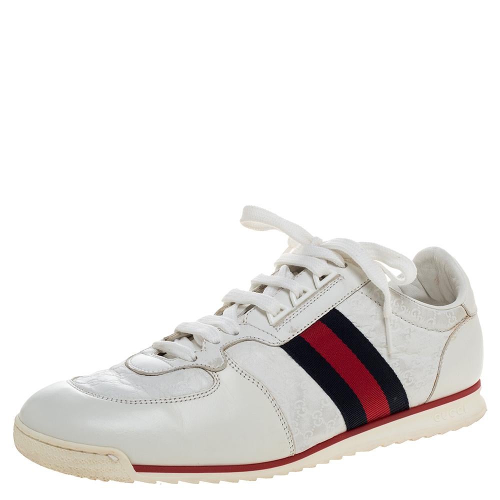 Stacked with signature details, this Gucci pair is rendered in white micro Guccissima leather and is designed in a low cut style with lace-up vamps. They have been fashioned with web trims at the quarters. Complete with the brand label on the