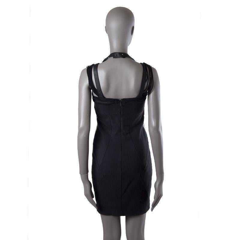 Gucci bodycon in black, off.white, blue violet, and maroon silk (96%) and elastane (4%). With fantasy neck that features leather straps, chord, and metal beading. Closes with one hook and invisible zipper on the back and adjustable snap on the back