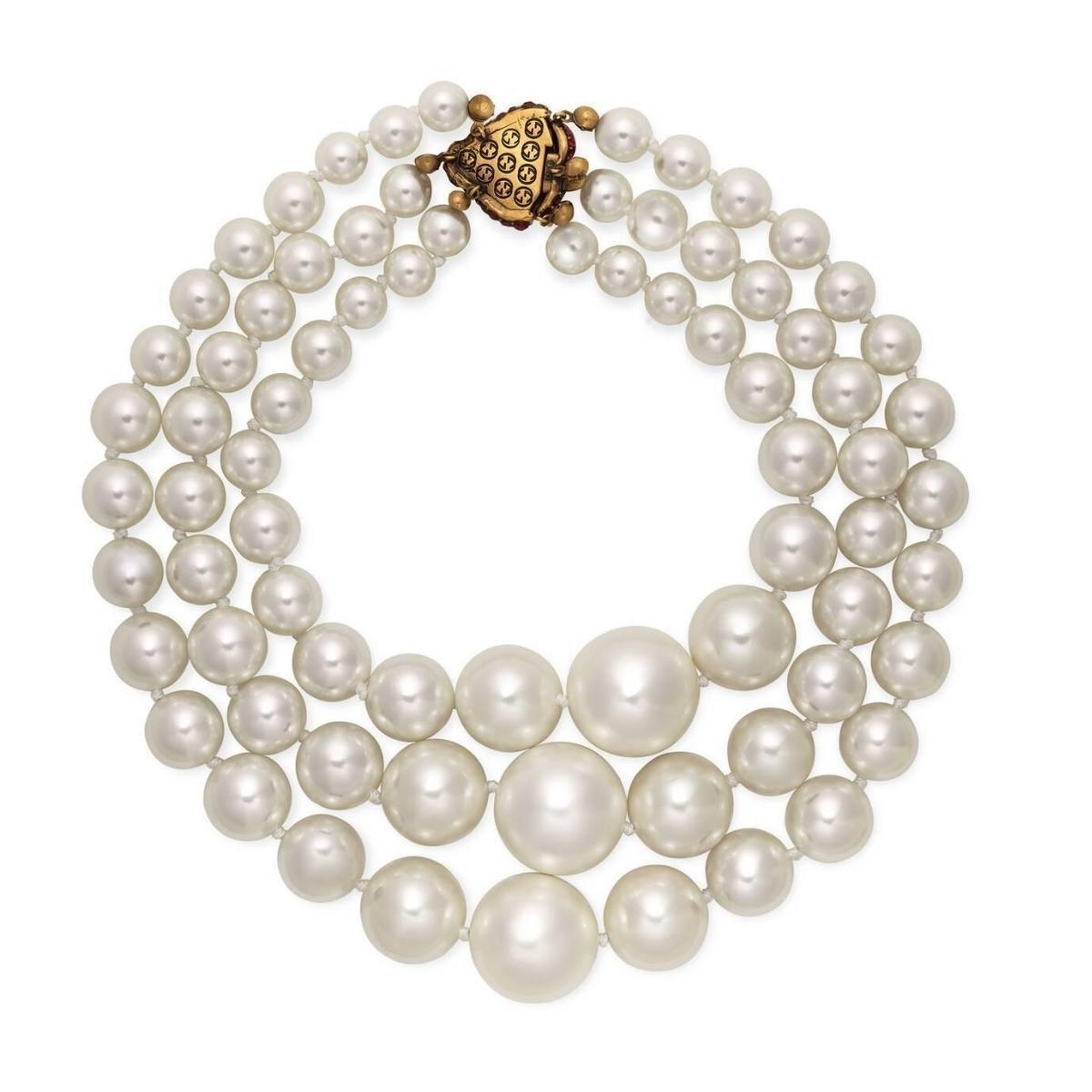 Three-layered faux-pearl necklace in white.
Crystal-embellished logo hardware throughout.
Red crystal-embellished press-release fastening.
Antiqued gold-tone hardware.
Approx. 18 length.
Supplier color: Pearl