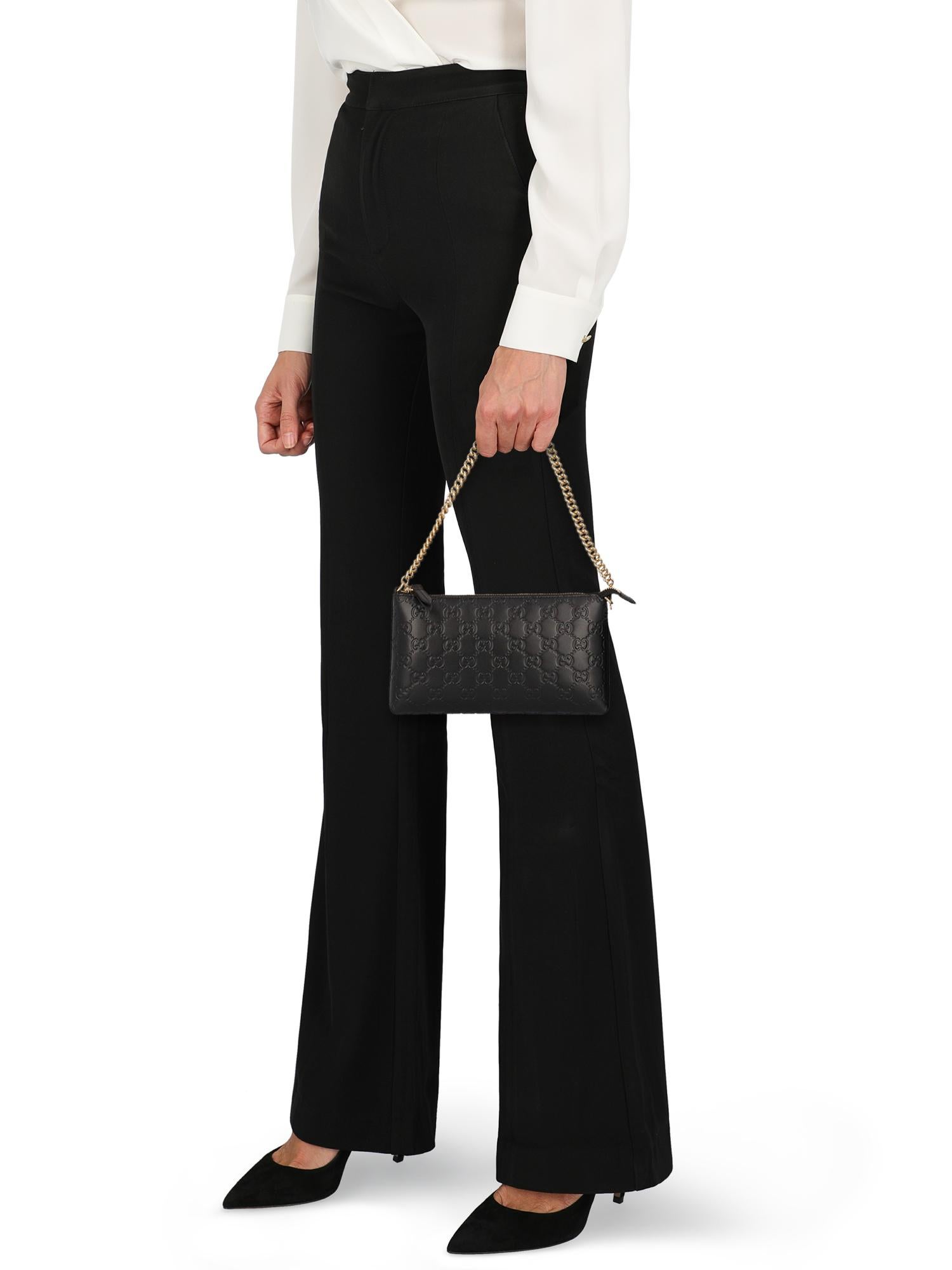 Product Description: Bag, leather, solid color, monogram logo, zipper fastening, gold-tone hardware, internal card slot, internal zipped pocket

Includes: 
- Dust bag

Product Condition: Excellent

Measurements:
Height: 12 cm
Depth: 2 cm
Width: 22