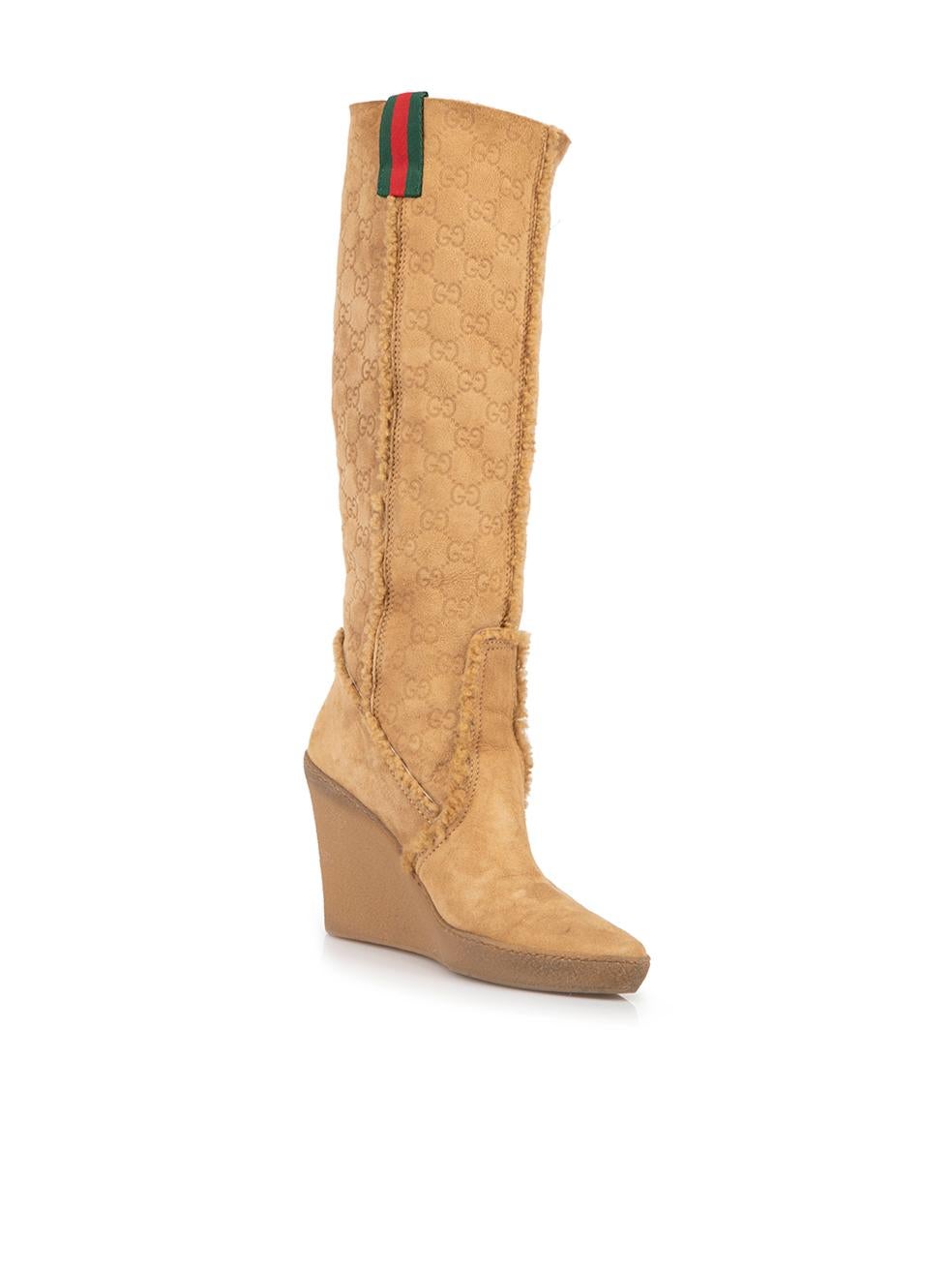 CONDITION is Very good. Minimal wear to boots is evident. Minimal wear to the suede exterior on this used Gucci designer resale item. 
 
 Details
  Camel
 Suede
 Knee high boots
 Almond toe
 Wedge heel
 GG Monogram pattern
 Shearling lined and