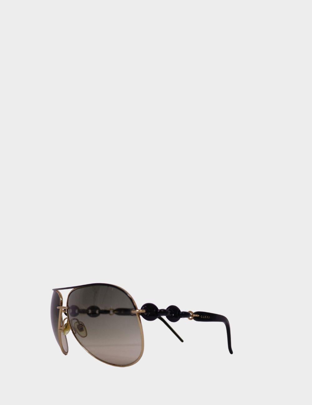 Elevate your sunny-day look with these statement Gucci aviator sunglasses, featuring a sleek gold-tone frame, gradient lenses, and distinctive black beaded detailing along the temples. Designed with a lightweight construction and subtle Gucci logo
