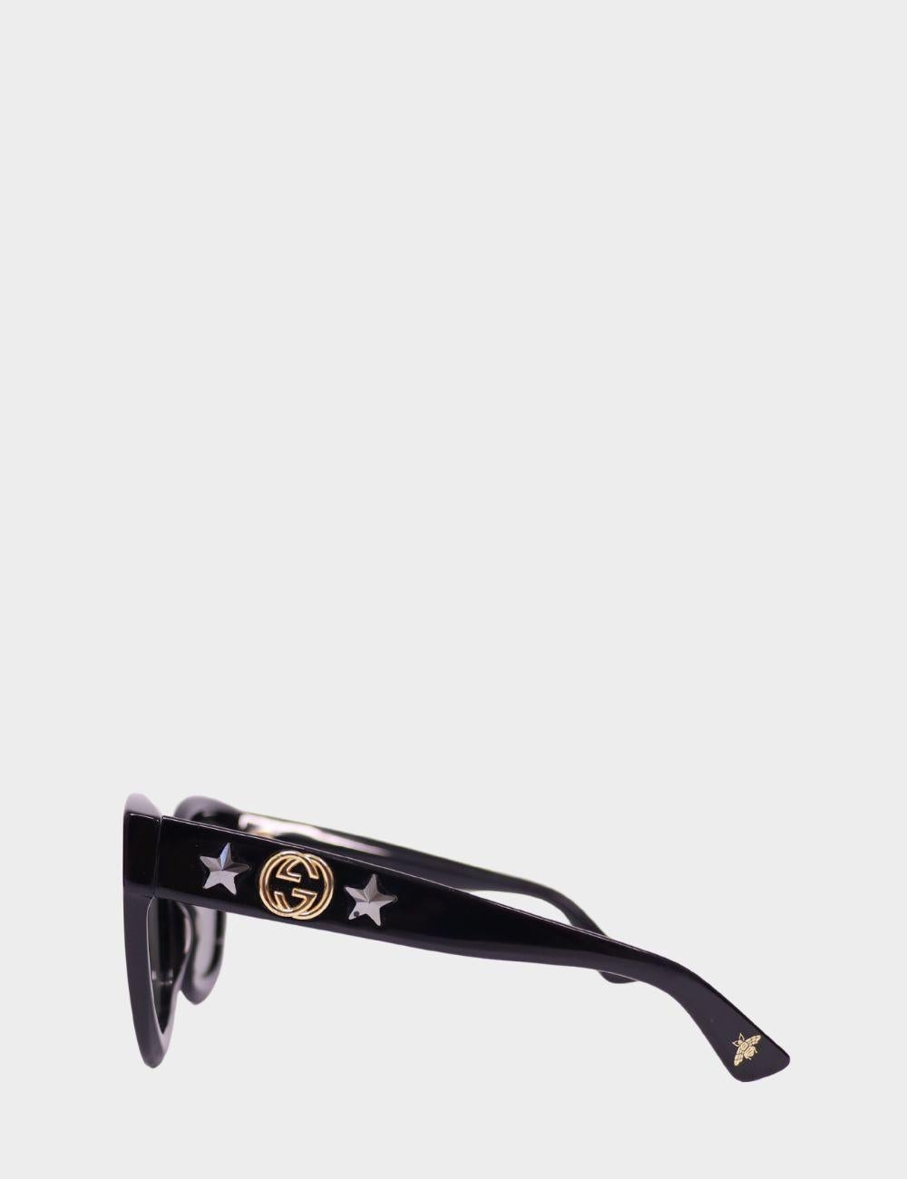 Luce un glamour desenfadado con estas gafas de sol negras de gran tamaño de Gucci, con una atrevida montura cuadrada, cristales oscuros y el logotipo dorado GG de la firma flanqueado por estrellas metálicas en las patillas. Estas gafas de sol de