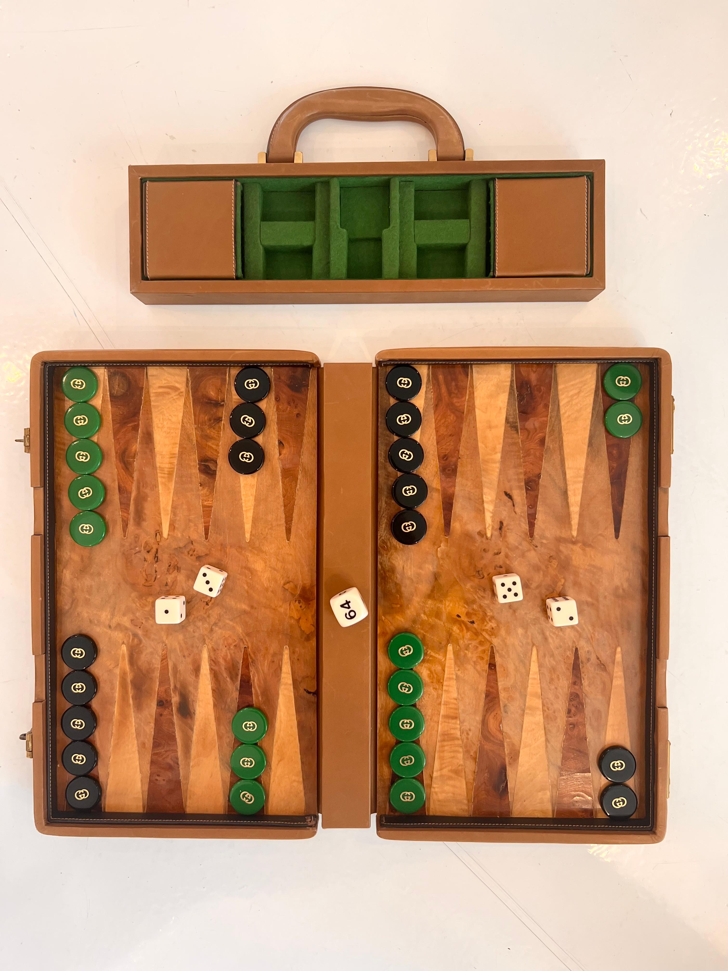 Vintage portable Gucci backgammon case/game. Tan leather trim with Burl wood on front and back of case and Burl wood game board/playing surface. 15 green and 15 black backgammon pips all present and in perfect condition. All with double G Gucci logo