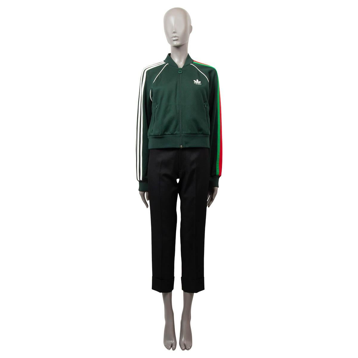 100% authentic Gucci x Adidas collection bomber jacket in forest green poyester (55%) and cotton (45%) jersey. This zip jacket features Gucci Trefoil embroidery, 3-stripes and green/red Gucci Web appliqué on the sleeves. The collection sees both