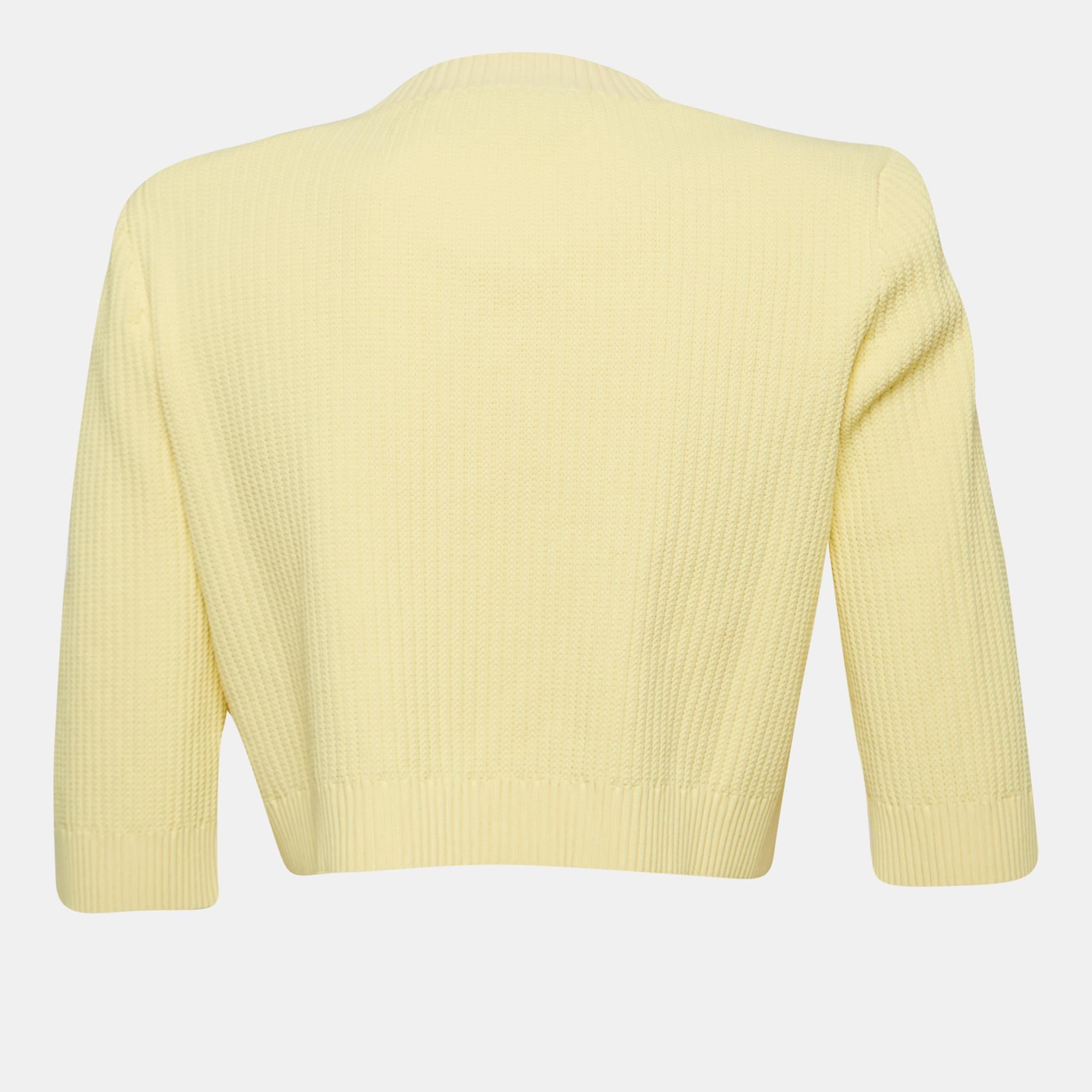The Gucci X Adidas cardigan is a vibrant and fashionable piece. Made from high-quality knit fabric, it features a bright yellow color, an oversized fit for a relaxed and cozy feel, and a buttoned front closure for added style. This cardigan combines