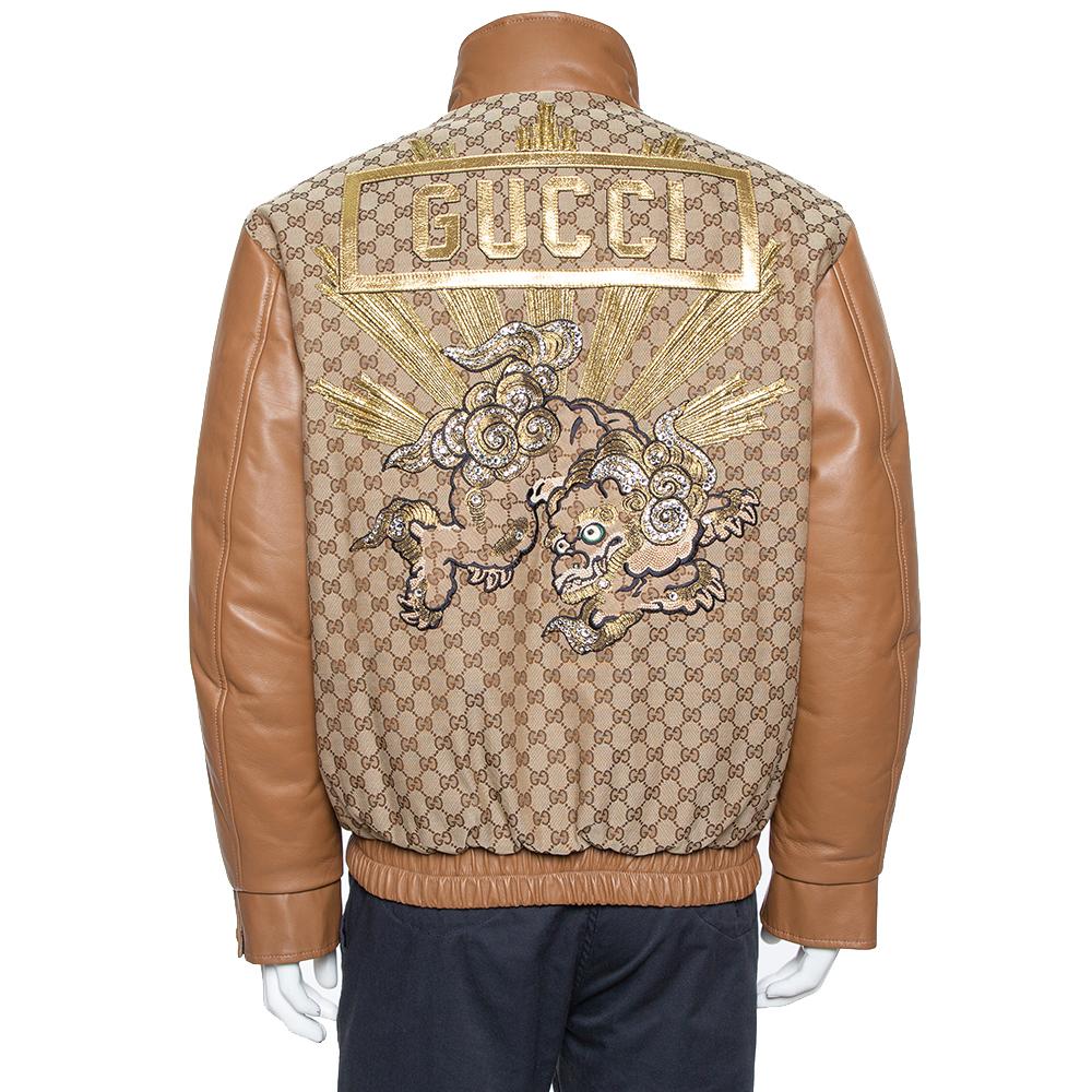 This varsity jacket from Gucci is a closet staple. Crafted from leather, it is styled in neutral shades with the signature GG print all over. This creation has an interesting design at the rear and long sleeves. It has been cut to deliver a