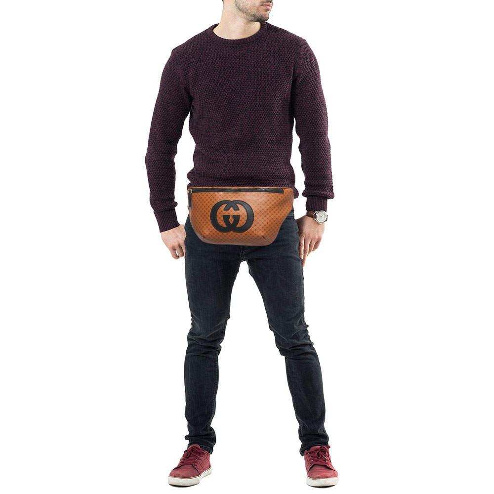 The Gucci X Dapper Dan belt bag combines luxury and streetwear featuring the iconic micro GG logo in brown leather. This compact accessory seamlessly blends fashion and function offering a stylish hands free storage solution with an adjustable belt