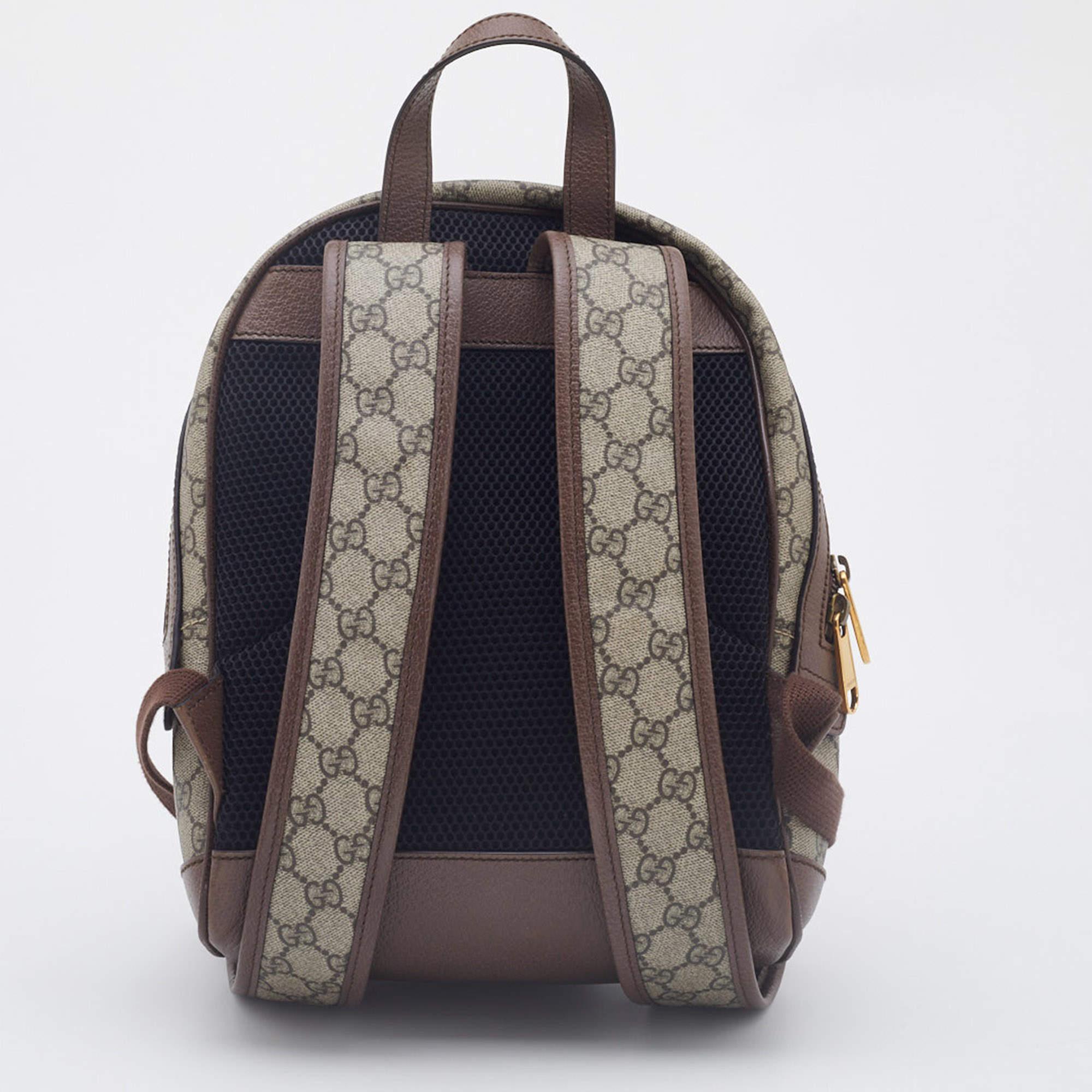 The Gucci x Disney backpack combines iconic luxury with playful charm. Crafted from beige GG Supreme canvas and leather accents, this backpack features a Donald Duck motif on the front pocket. It has a spacious main compartment, adjustable shoulder